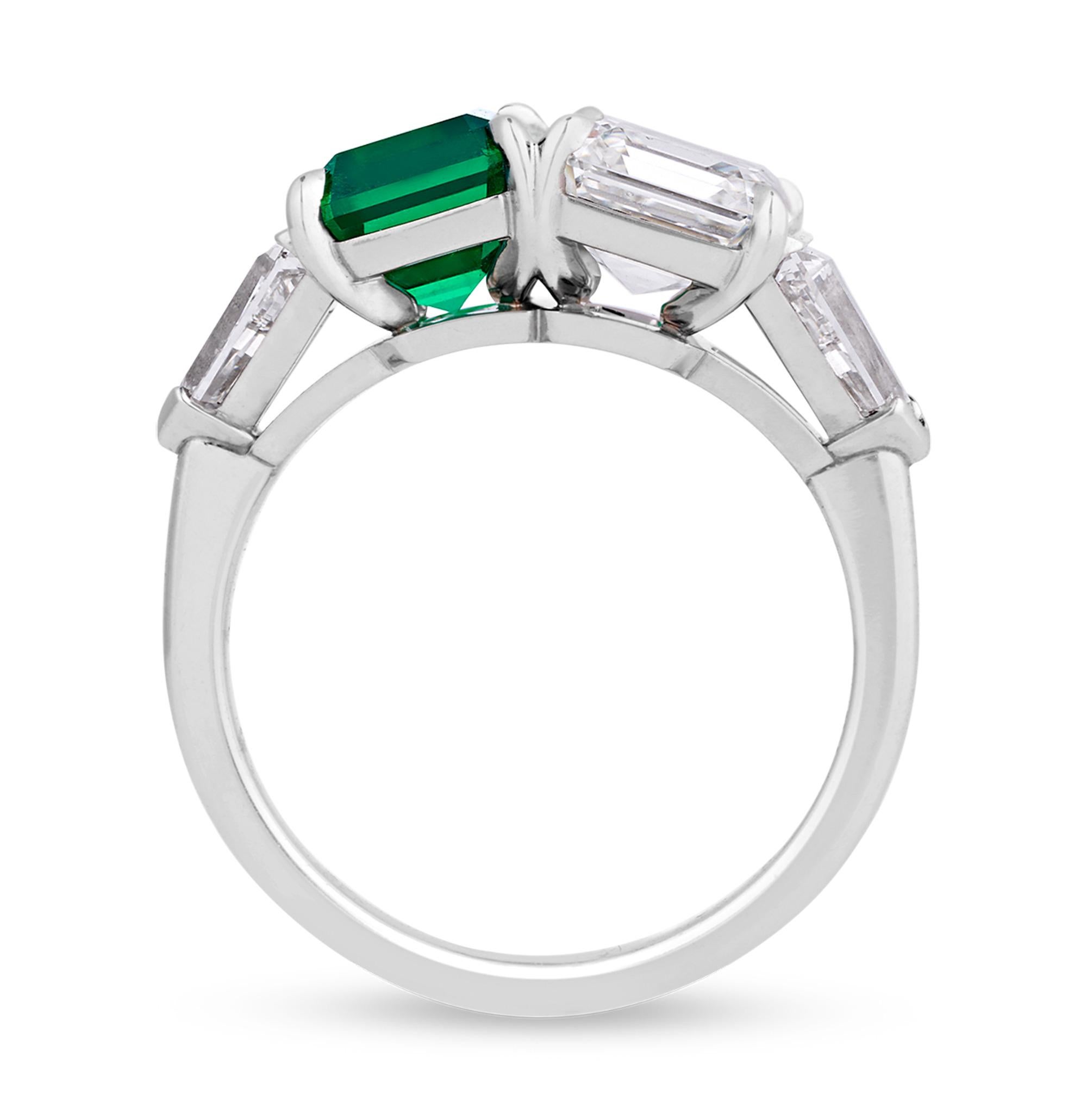 Two incredible, perfectly matched gemstones are paired together in this stunning twin-stone ring. The 1.51-carat GRS-certified Colombian emerald displays a mesmerizing velvety green, known to collectors as the coveted Muzo Old Mine hue. An elegant