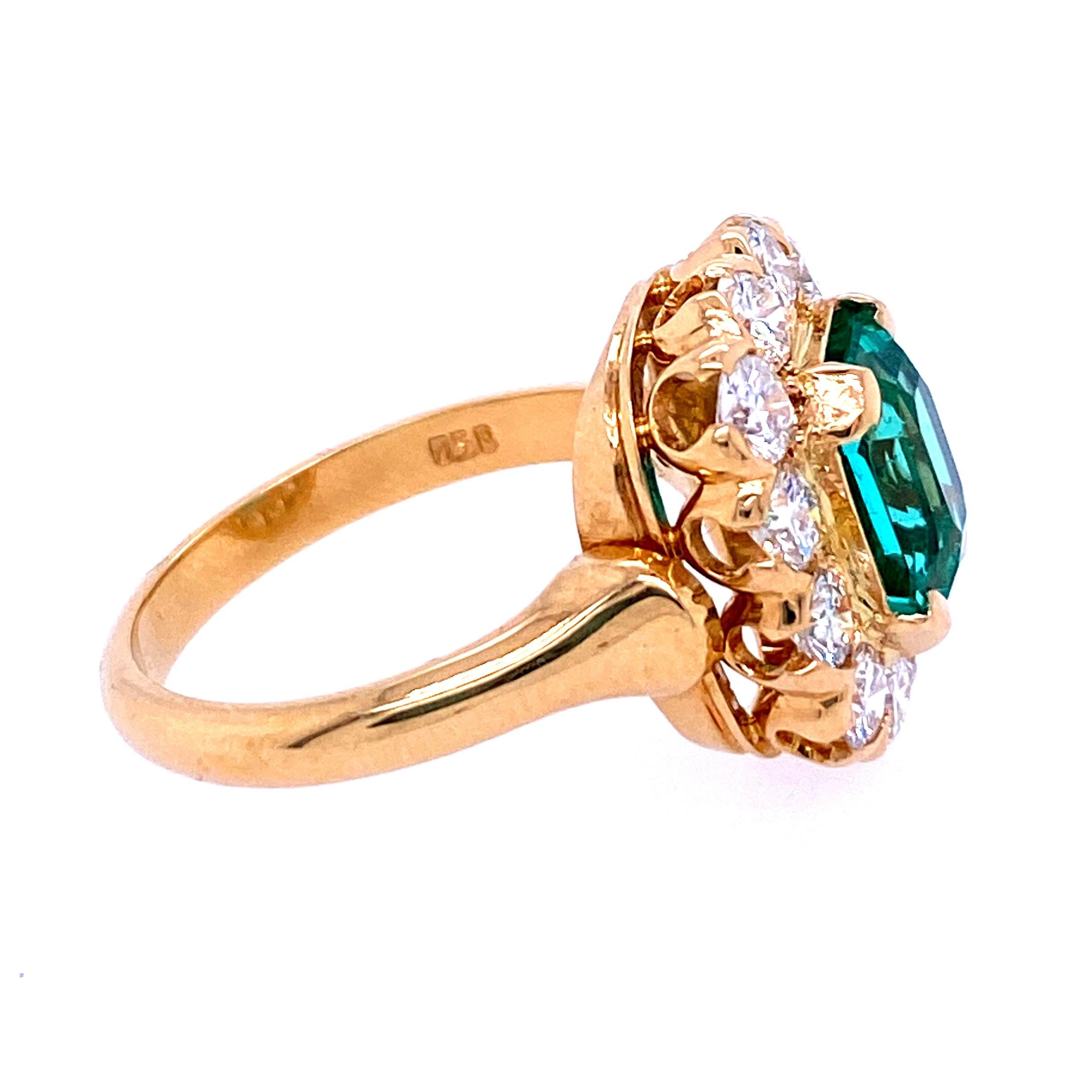 18kyg ring with one 2.17 carat rectangular step cut Colombian emerald accompanied by AGL report # 1105944 surrounded by twelve round brilliant diamonds, 1.20 carats total weight with matching E/F color and VS1-SI1 clarity. 