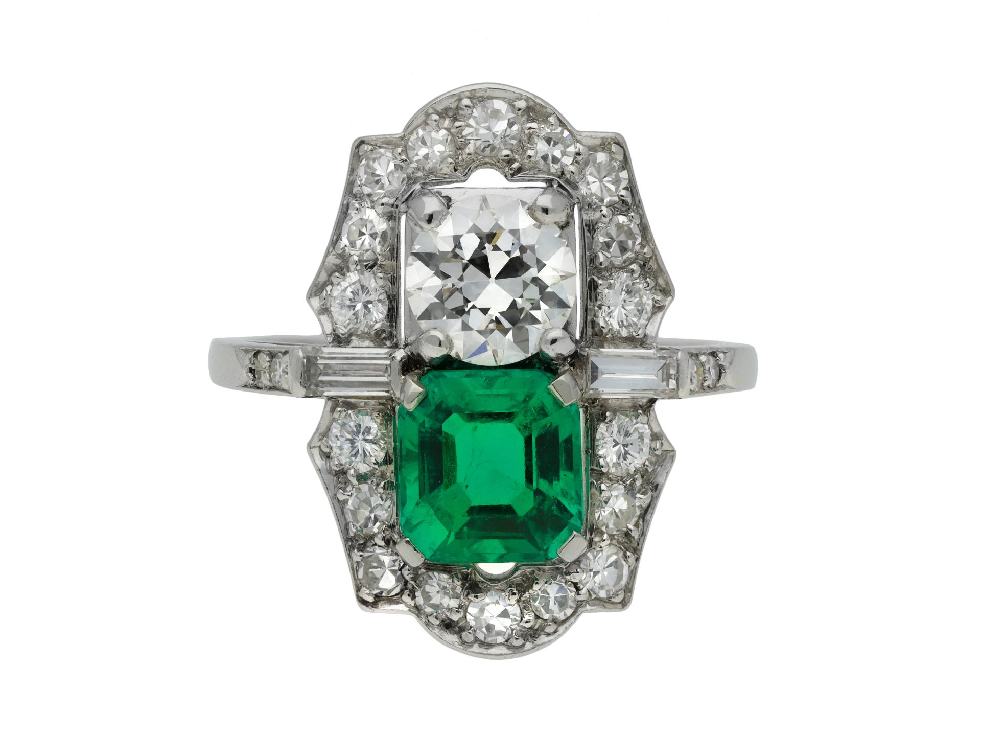 Colombian emerald and diamond two stone cluster ring. Set to centre with an octagonal emerald cut natural Colombian emerald with no colour enhancement and minor clarity enhancement in an open back claw setting with an approximate weight of 1.50