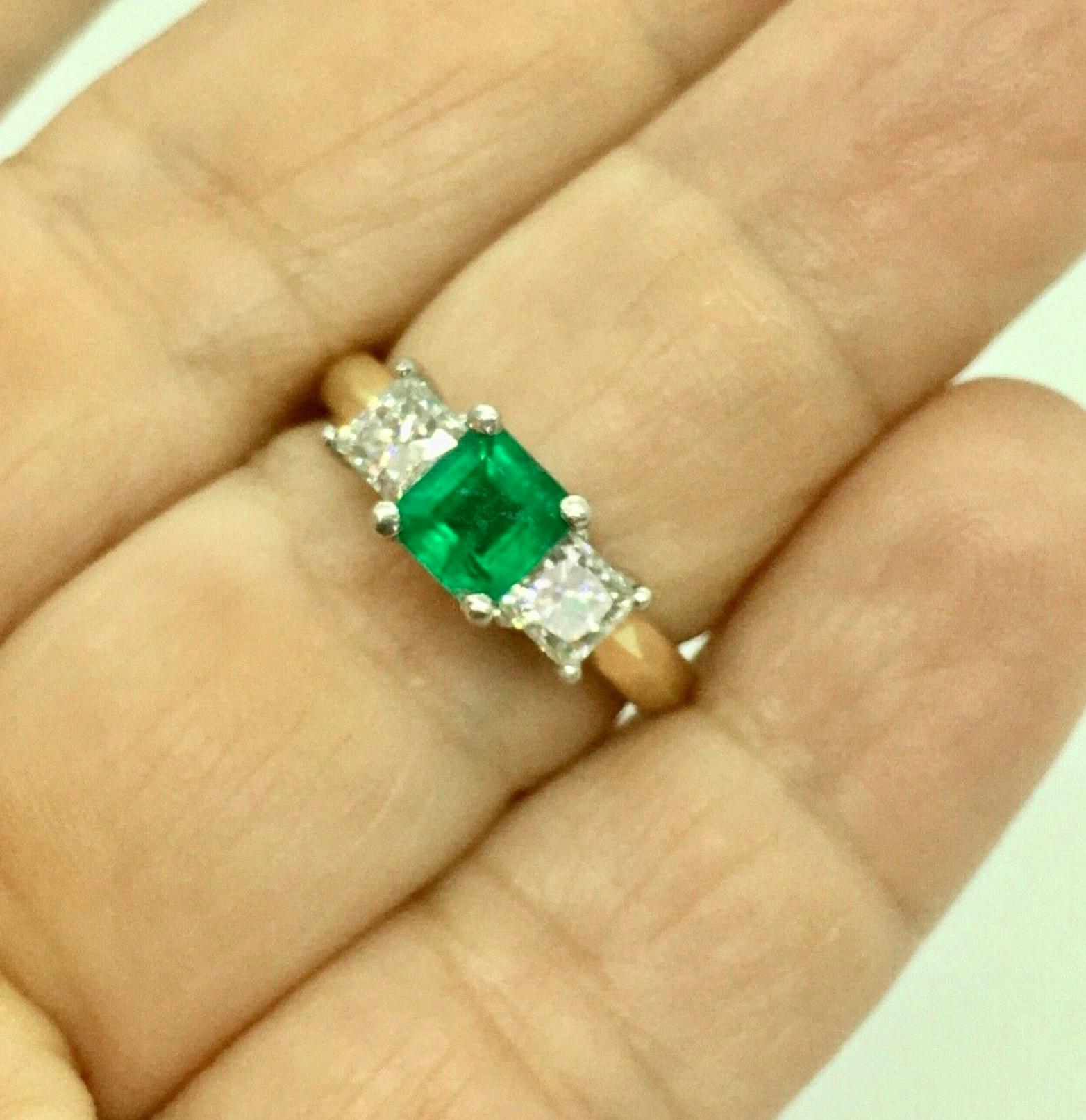 Fine Three Stone 18K Gold and Platinum Engagement Ring 
Center: Fine Natural Colombian Emerald .85 Carat Vivid Medium intense Green
Side: two Natural  princes Cut Diamonds 0.70 Carat SI1-H
Weight   5.8 g
Ring Size 6.5
Estate Piece/Excellent