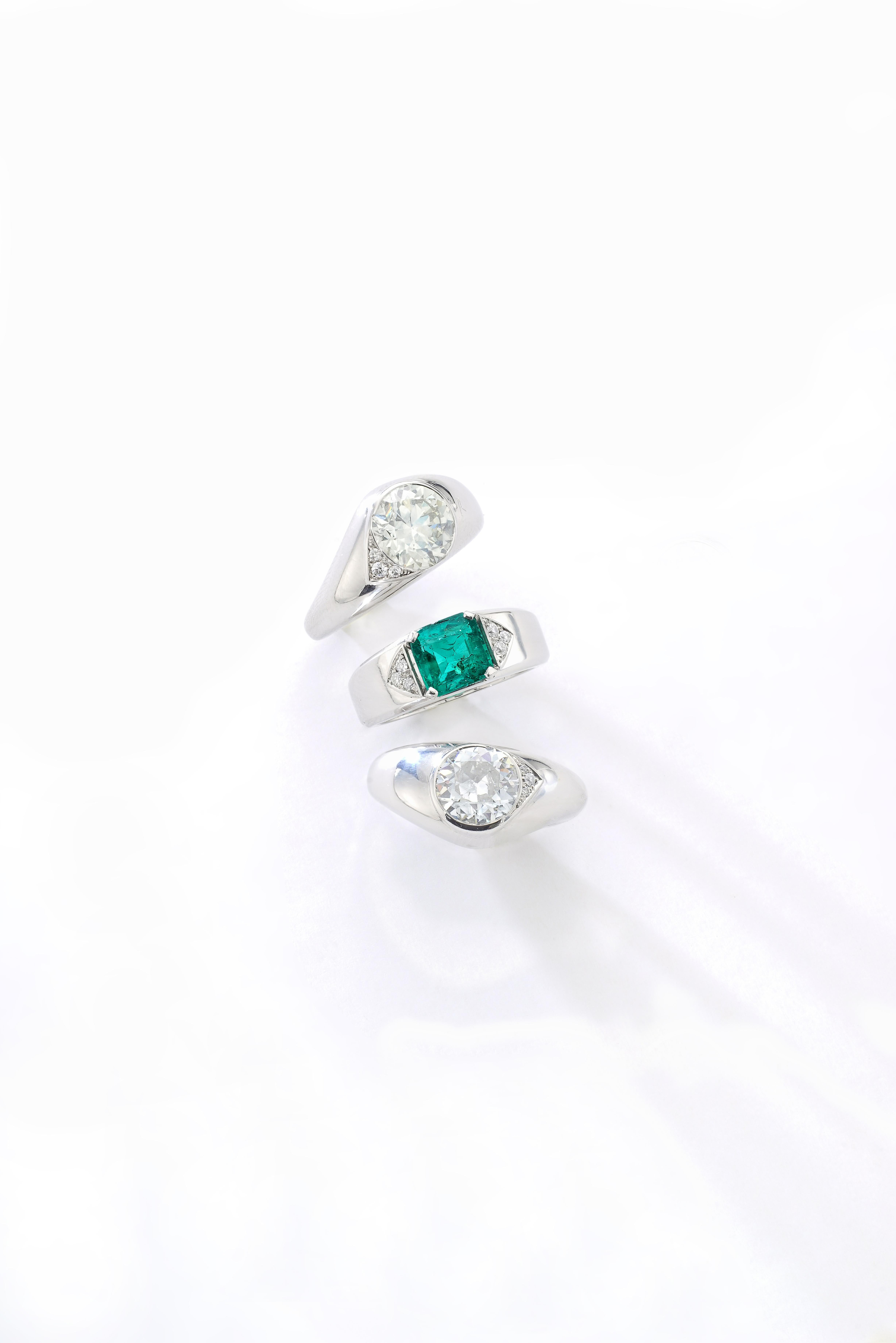 2.90 carat approx. / 1.97 carat approx. Diamonds / 1.70 carat approx. Emerald Old Mine Colombian exceptional green color on platinum surrounded by small diamonds. 
Three Rings can be worn altogether or splitted.
French marks.
Size 51.