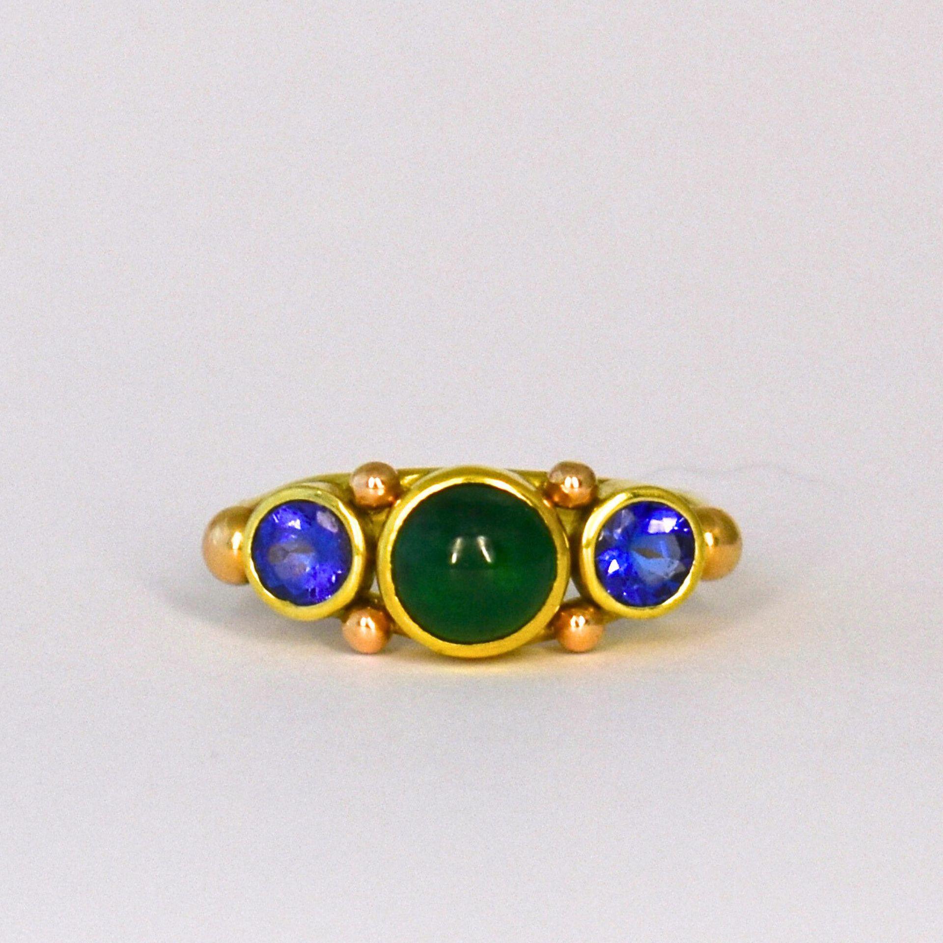 Experience the allure of our handcrafted Cabochon Colombian Emerald Sapphire Ring, an exquisite work of art by Lynn Kathyrn Miller, a renowned artisan at Lynn K Designs. This ravishing piece of fine jewelry is a testament to our dedication to