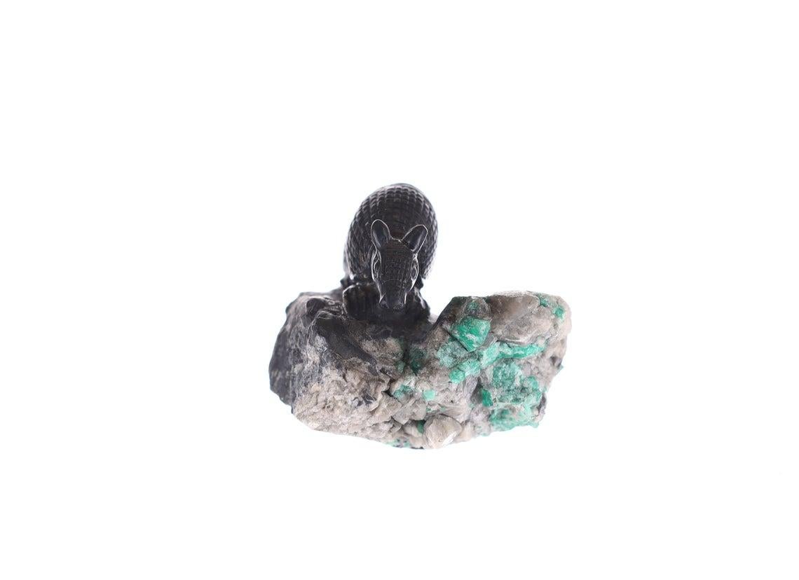 Rough Emerald-
Color: Green
Clarity: Opaque
Origin: Colombia

Sculpture-
Stone(s): Black Shale, Gray Shale, Calcite
Measurement: 4.5