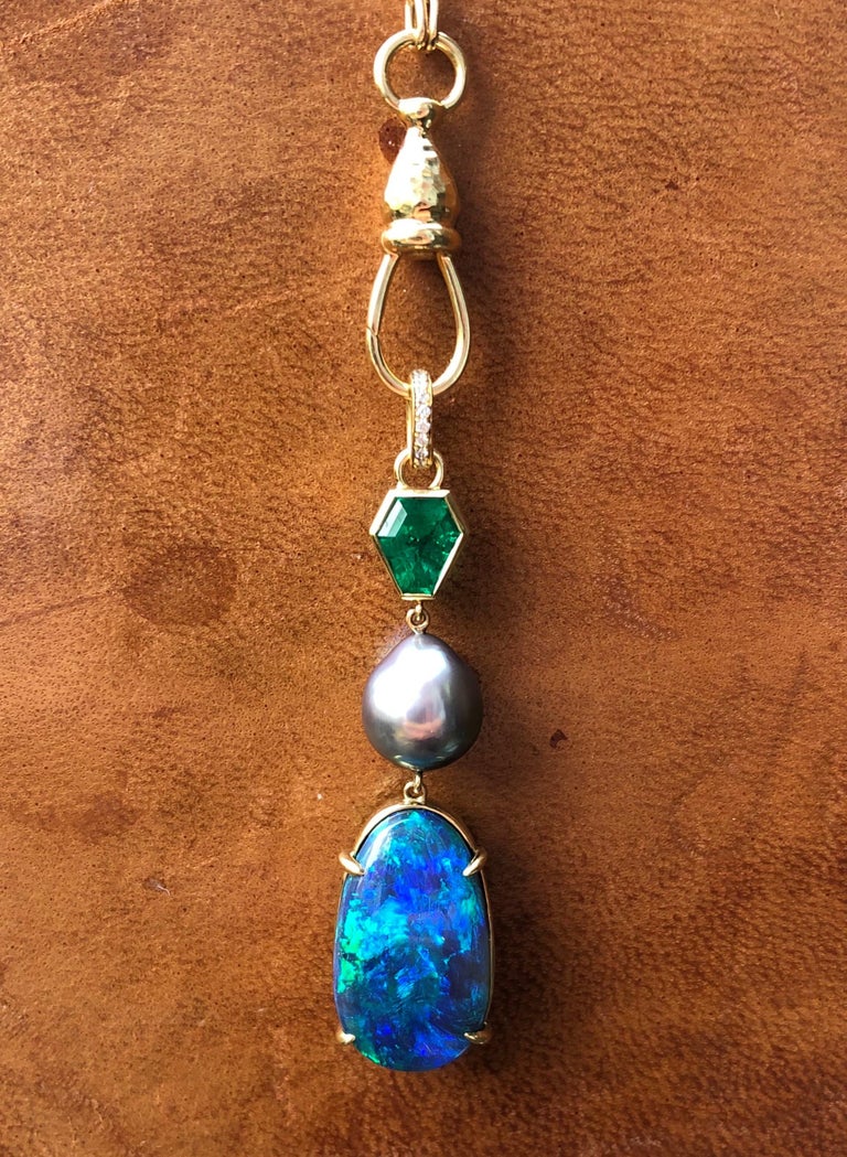 This piece was made to honor color and phenomenal gems. This pendant features a 1.29 carat shield cut Muzo Colombian emerald, a rare baroque AAA Sea of Cortez Pearl and a solid Australian Lightening Ridge opal, with VS diamonds accented on the bail.