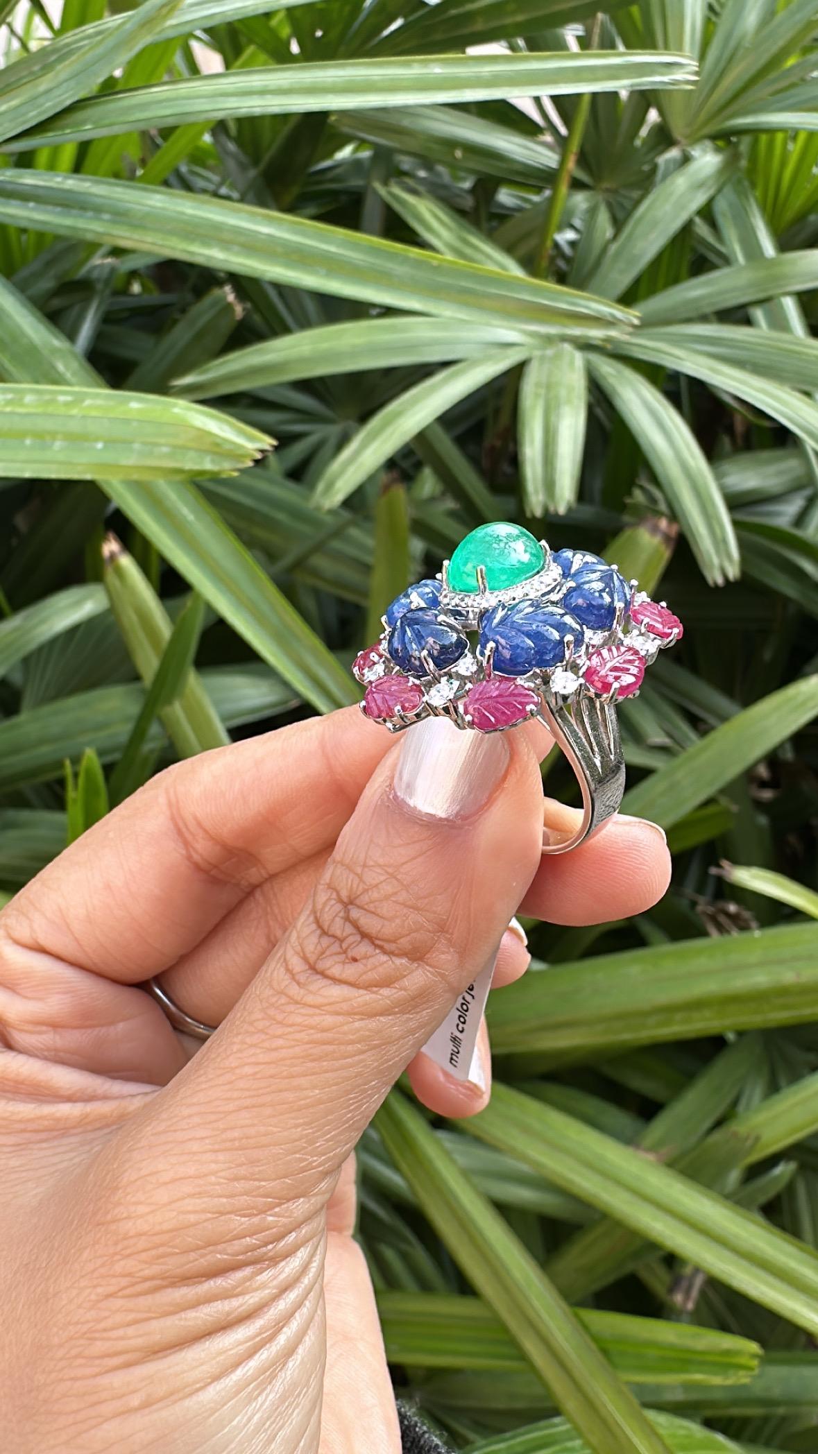 A very gorgeous and beautiful, Emerald, Blue Sapphires & Ruby Cocktail Dome Ring set in 18K White Gold & natural Diamonds. The weight of the Emerald Cabochon is 2.93 carats. The Emerald is completely natural, without any treatment and is of