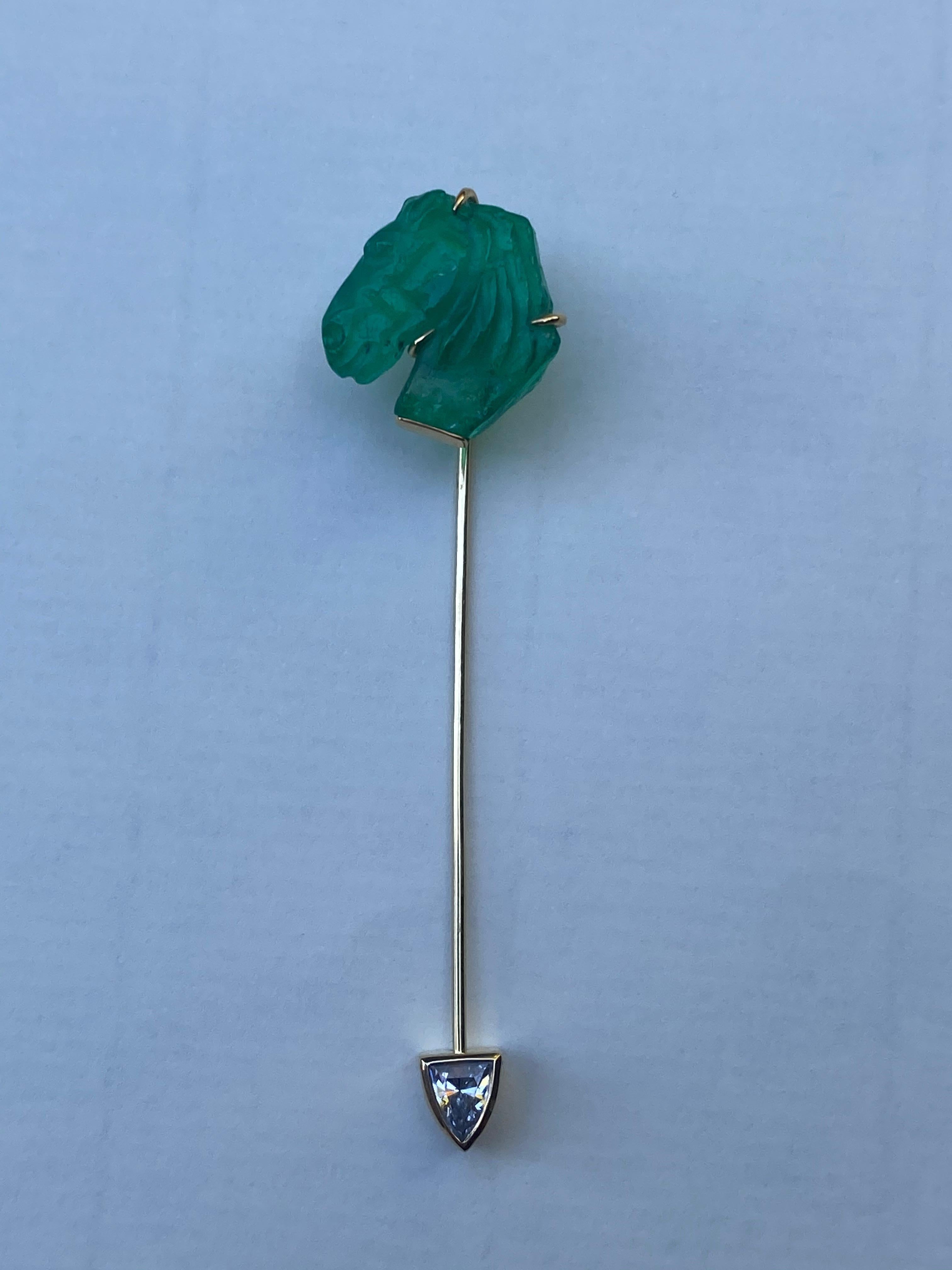 This lapel pin features a 5.7 carat hand carved Colombian Emerald in a hand forged 18 and 22 karat gold setting and clasp. The shield cut diamond on the clasp is F-VS2, and 0.27 carats.
For a collector. 


Colombian emerald hand carved horse head-