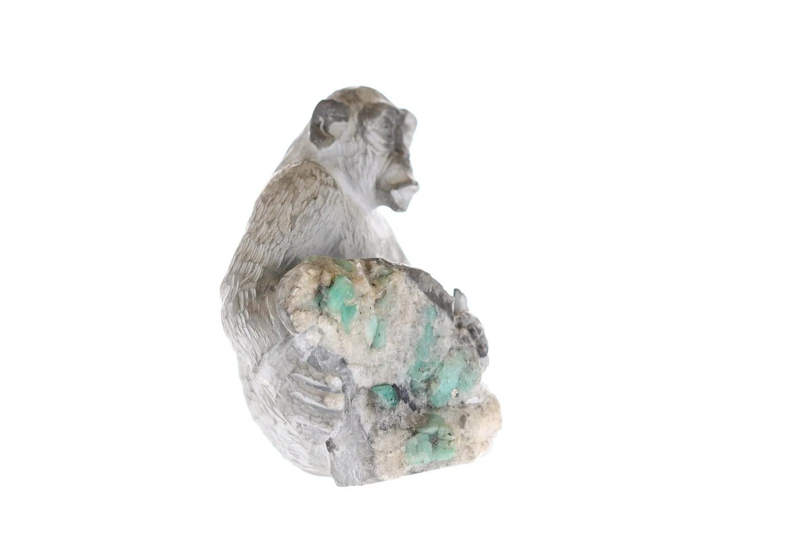 This is a beautiful and one-of-a-kind rough Colombian emerald sculpture. Featuring an incredible chimpanzee, in its natural habitat. Made of white and gray shale, as it holds a stomp of pure natural Colombian emerald roughs. It simply cannot get any