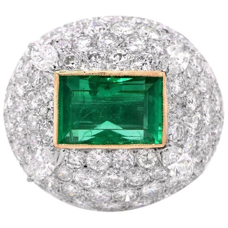 This stunning dome ring is centered with a vibrant high quality emerold-cut Colombian Emerald  weighing approx: 3.20 carats; GIA certified to BE Colombian origin and F1 Rating( no treatment except for moinr minoral Oil)  to preserve its beatybezel