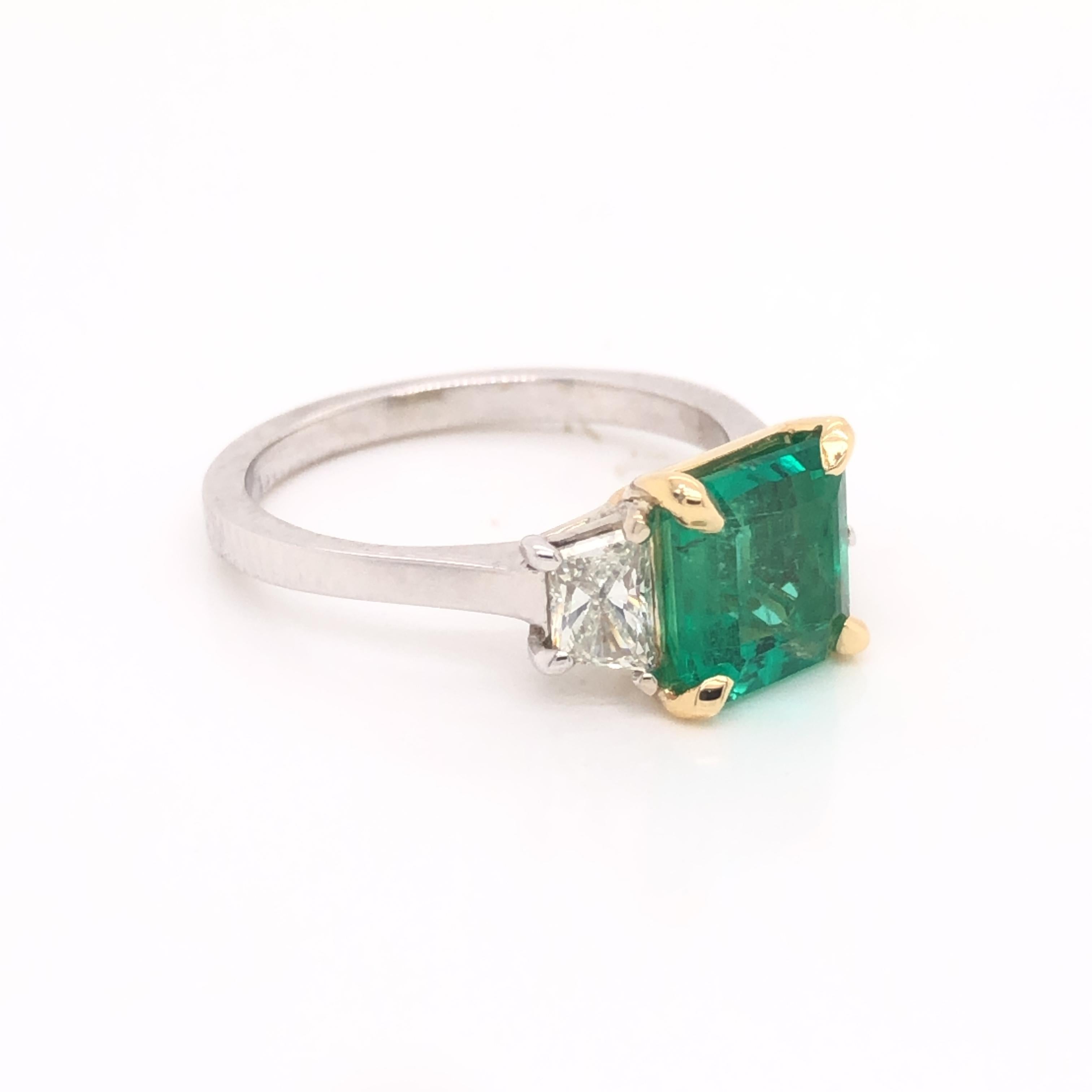 One phenomenal ring crafted in 18k white gold. The ring is highlighted with one emerald gemstone showing an emerald cut. The gemstone shows a vivid green color as it is Colombian in origin. Colombia is known to produce the highest quality emerald