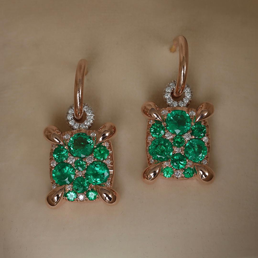 Handcrafted with unparalleled precision in Belgium by the renowned designer Joke Quick, these exquisite charm earrings feature an elegant cushion shape, pave set with Vibrant Muzo Colombian emeralds and sparkling diamonds. 

These earrings feature a