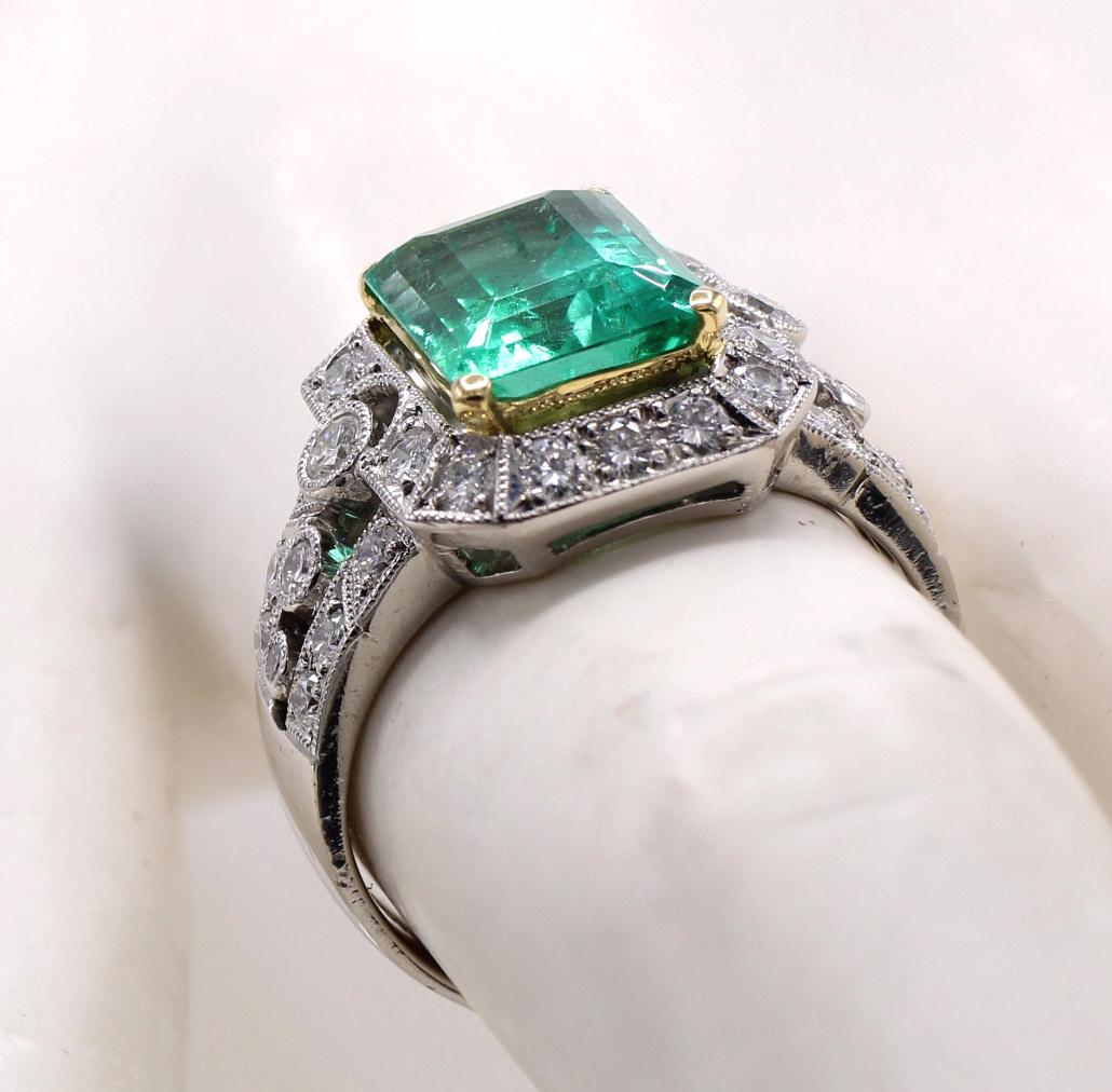 A perfectly cut Colombian emerald weighing 3.71 carats is the center piece of this beautifully designed and finely handcrafted ring. The lively brilliant emerald set in a 18 karat yellow gold basket is embellished by bright white and sparkly round
