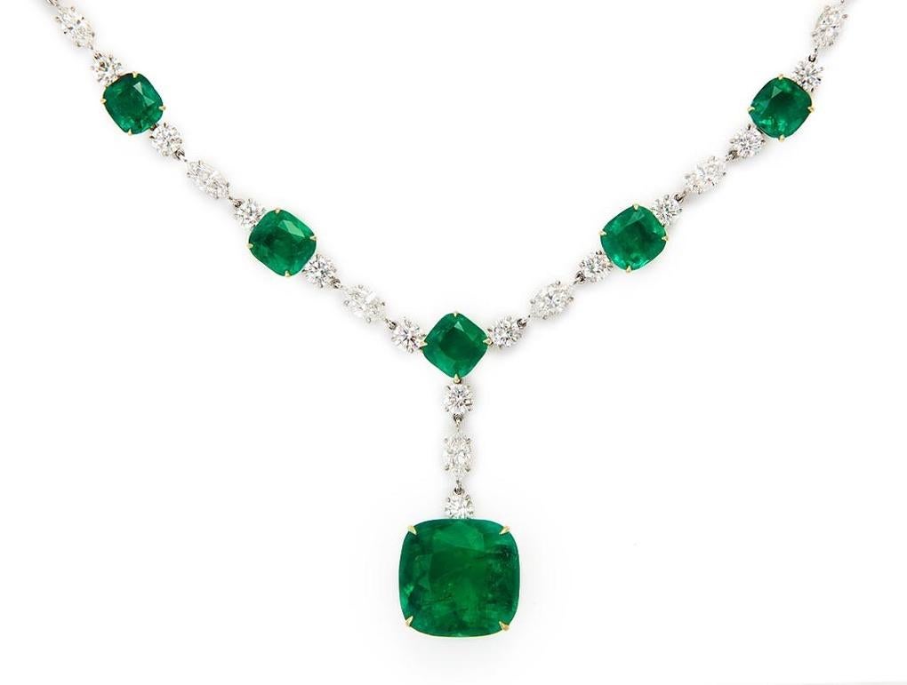 The finest, perfectly matched collection of cushion cut emeralds (all certified) encircle the neck, culminating in an exquisite pendant featuring a single emerald weighing app. 34 carats.  Throughout the necklace the emeralds are connected by the