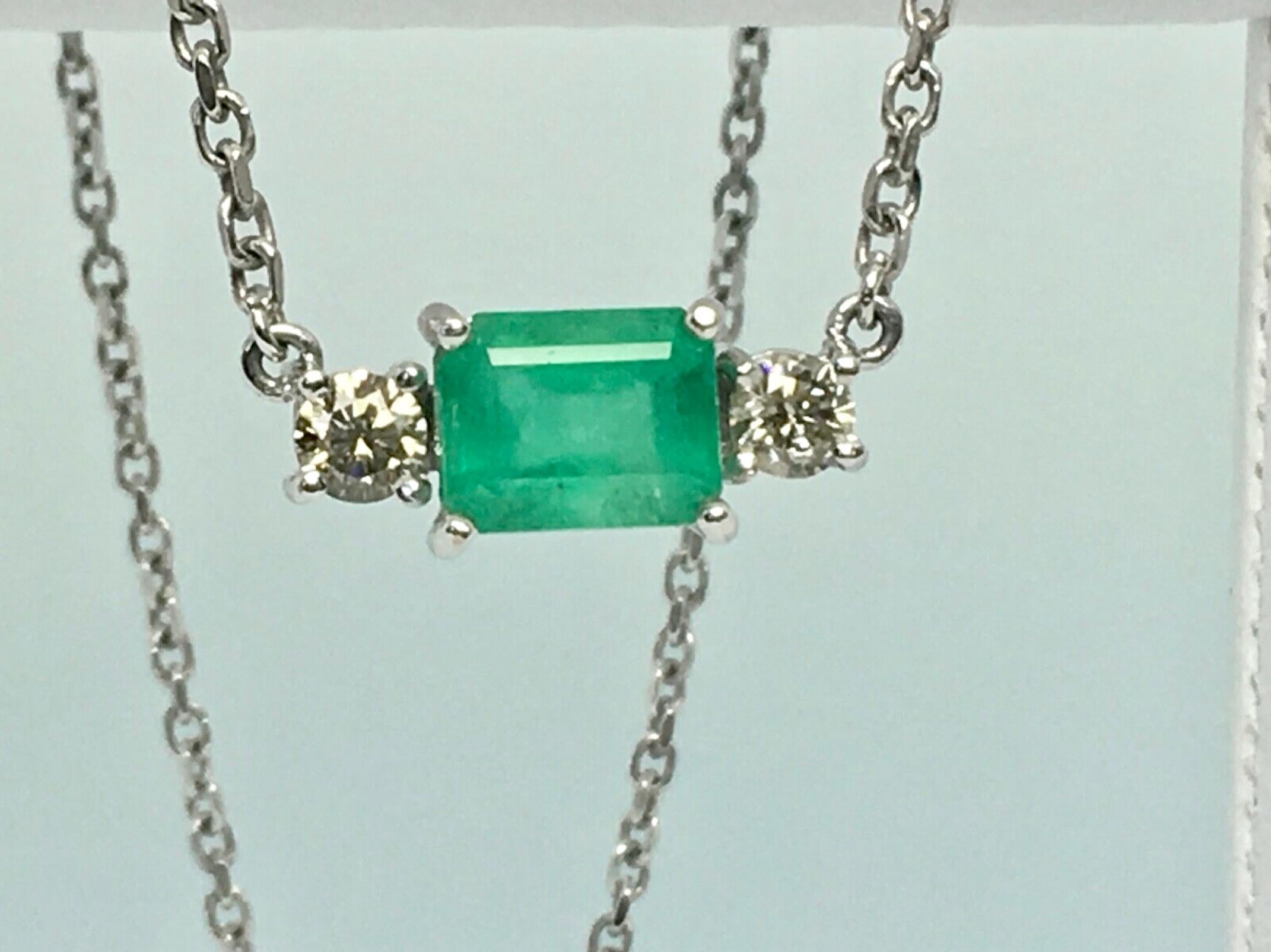 Natural Colombian Emerald Emerald Cut 2.50 Carat and Two Natural Diamond .60 Carat  SI1-SI2/ Light Champagne Color.
The Colombian emerald shows a nice medium green /Very good clarity & transparency.  
Mounting Is Custom Made of Solid 18K white Gold
