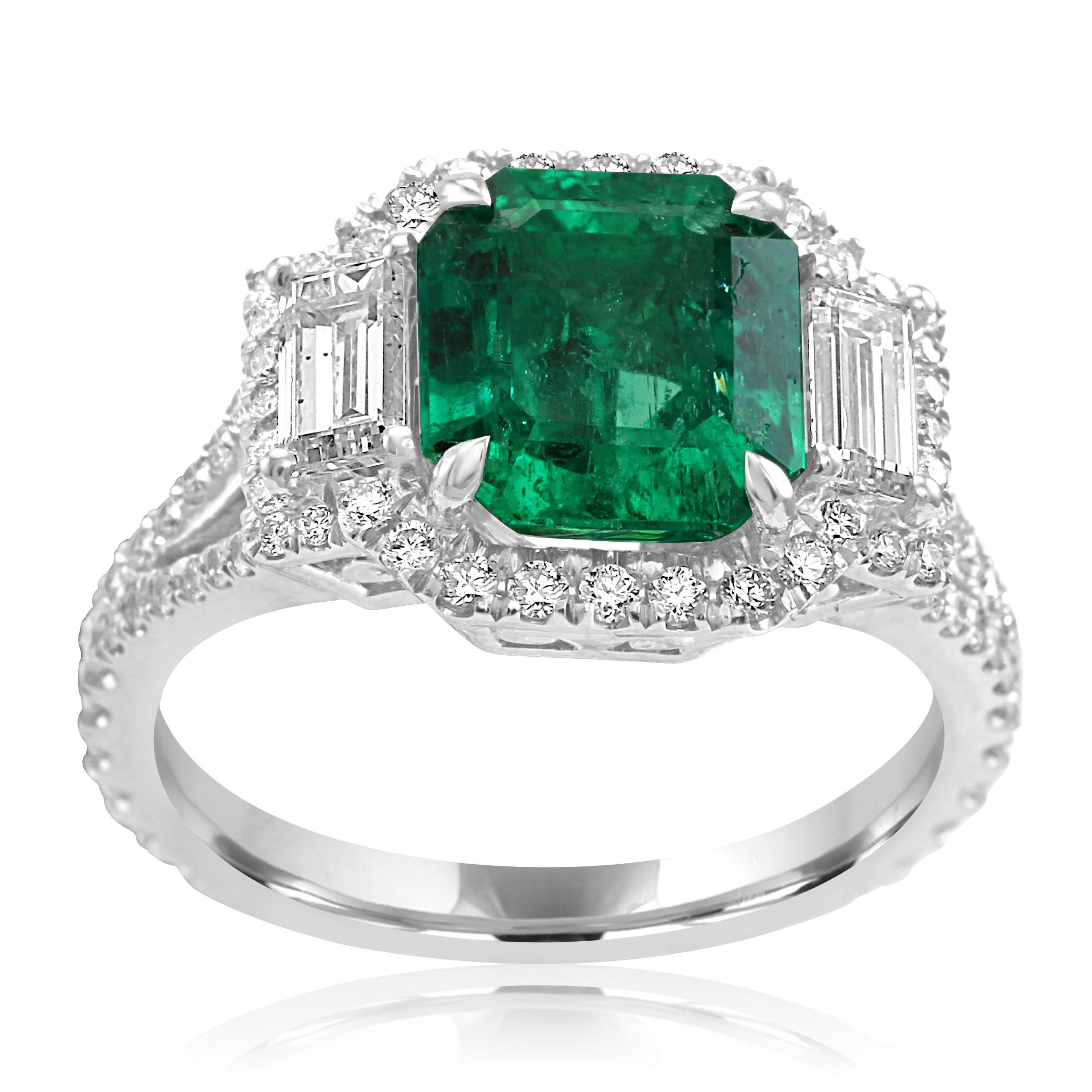 Stunning Colombian Emerald, Emerald Cut 2.42 Carat flanked by 2 White G-H color VS-SI clarity Diamond Baguettes 0.57 carat encircled in a single Halo of White G-H Color VS-SI Clarity 0.70 Carat set in Gorgeous 18K White Gold Three Stone Fashion