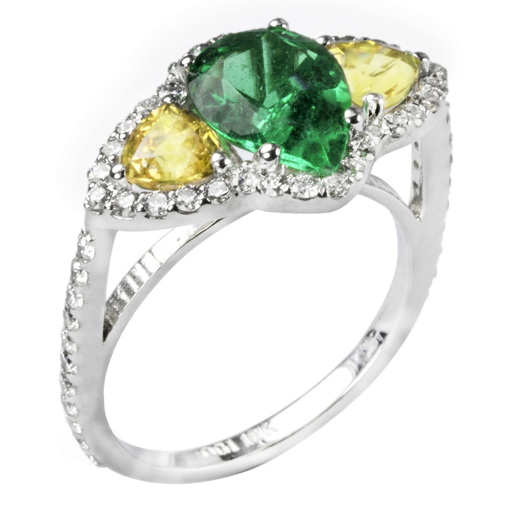 18 karat white gold one of a kind cocktail ring 
Pear shape Colombian emerald weighing 1.50
Two matched triangle yellow sapphires side stones weighing 1.21 carat 
Surrounded by pave-set diamonds weighing 0.65 carats  
Diamond quality G VS
New