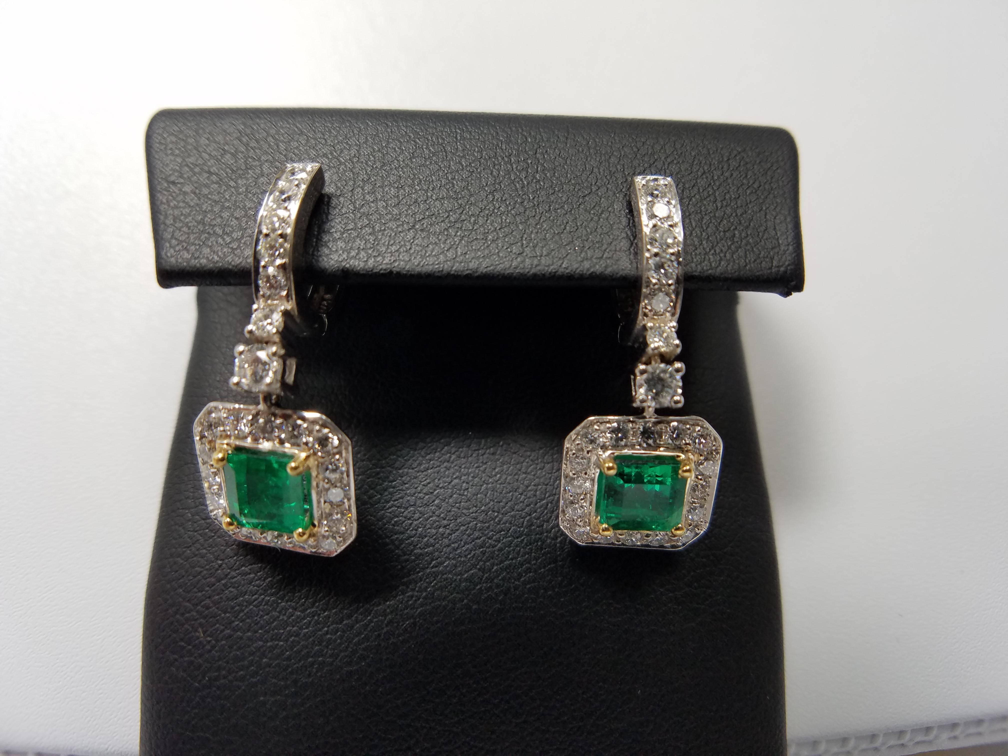 2 Fine Colombian Emeralds Earrings, each one having a center stone of aprox 0.80 carats. Set in both 18k white gold and 14k yellow gold with 46 total diamonds weighing aprox. 1.30 carats. 
