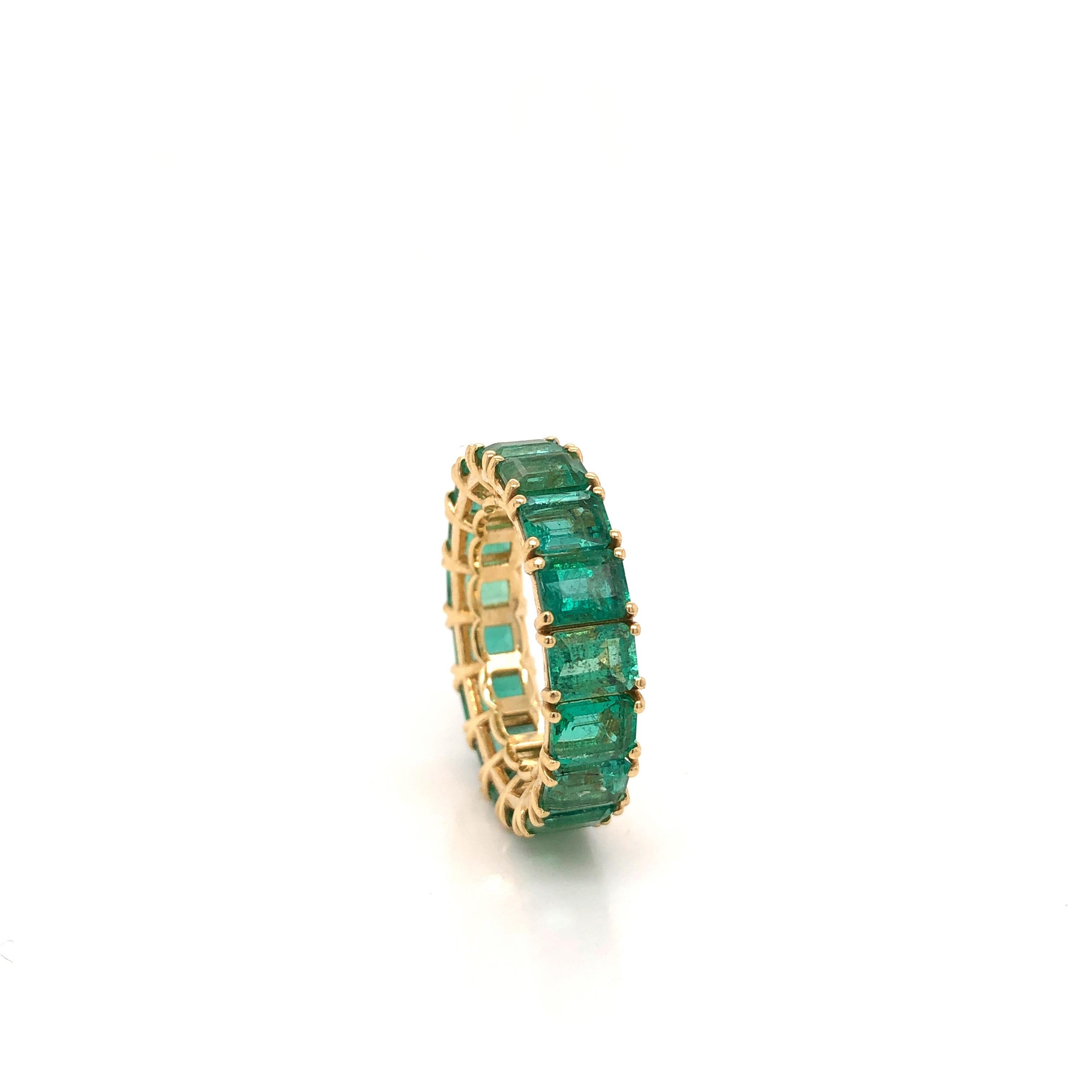 Amazing hand crafted 18k yellow gold Colombian Emerald eternity band. This ring is truly breathtaking. Each stone was matched to perfection to create this one of a kind ring. Seventeen Emeralds are set into this band, all showing a vibrant green