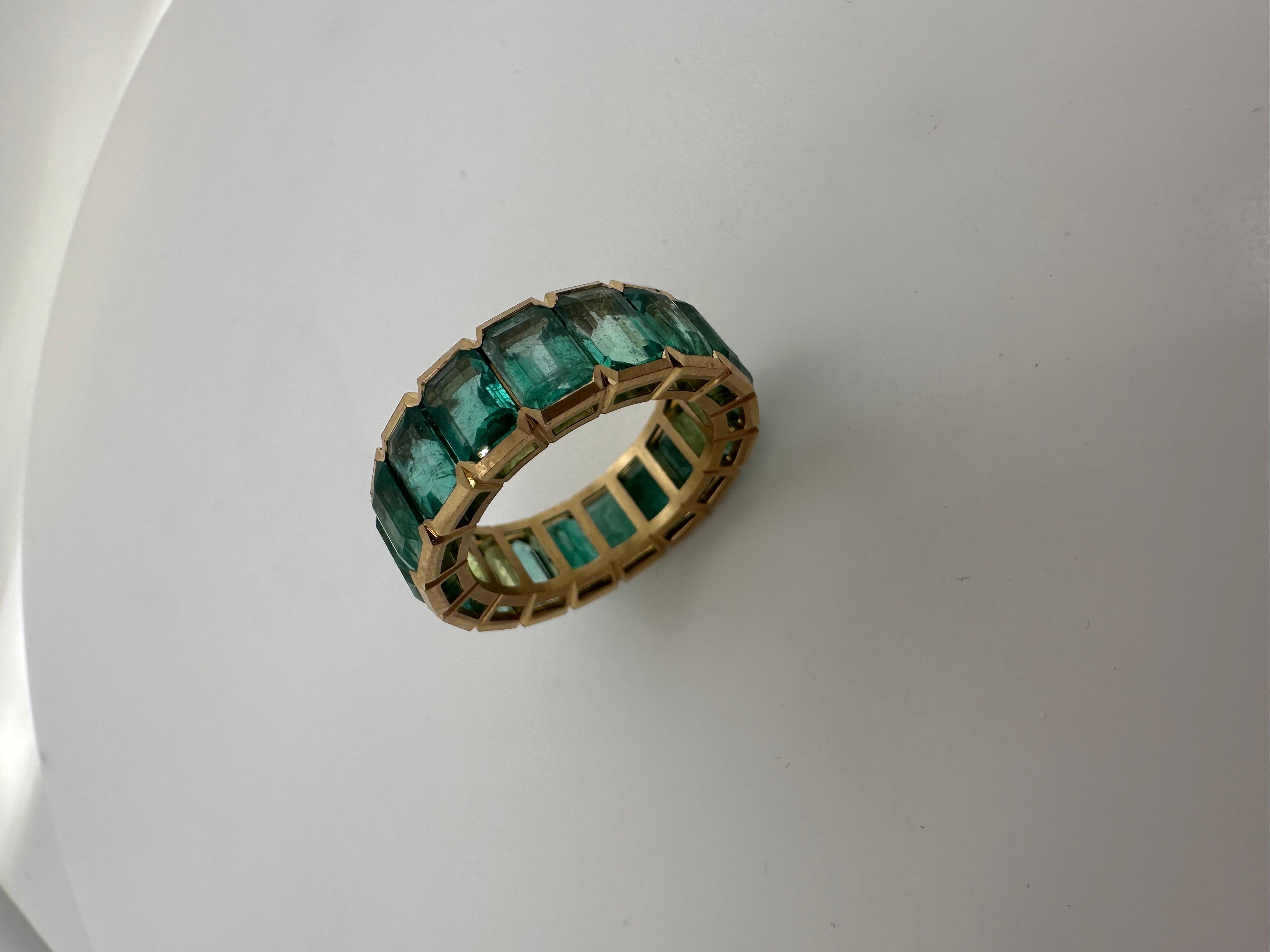 One of a kind Colombian emerald eternity ring made with natural bluish green emeralds in 18KT yellow gold with matte finish for that extra character! Very unique ring!

Metal Type: 18KT

Natural Emerald(s): 
Color: Bluish Green
Cut:Emerald