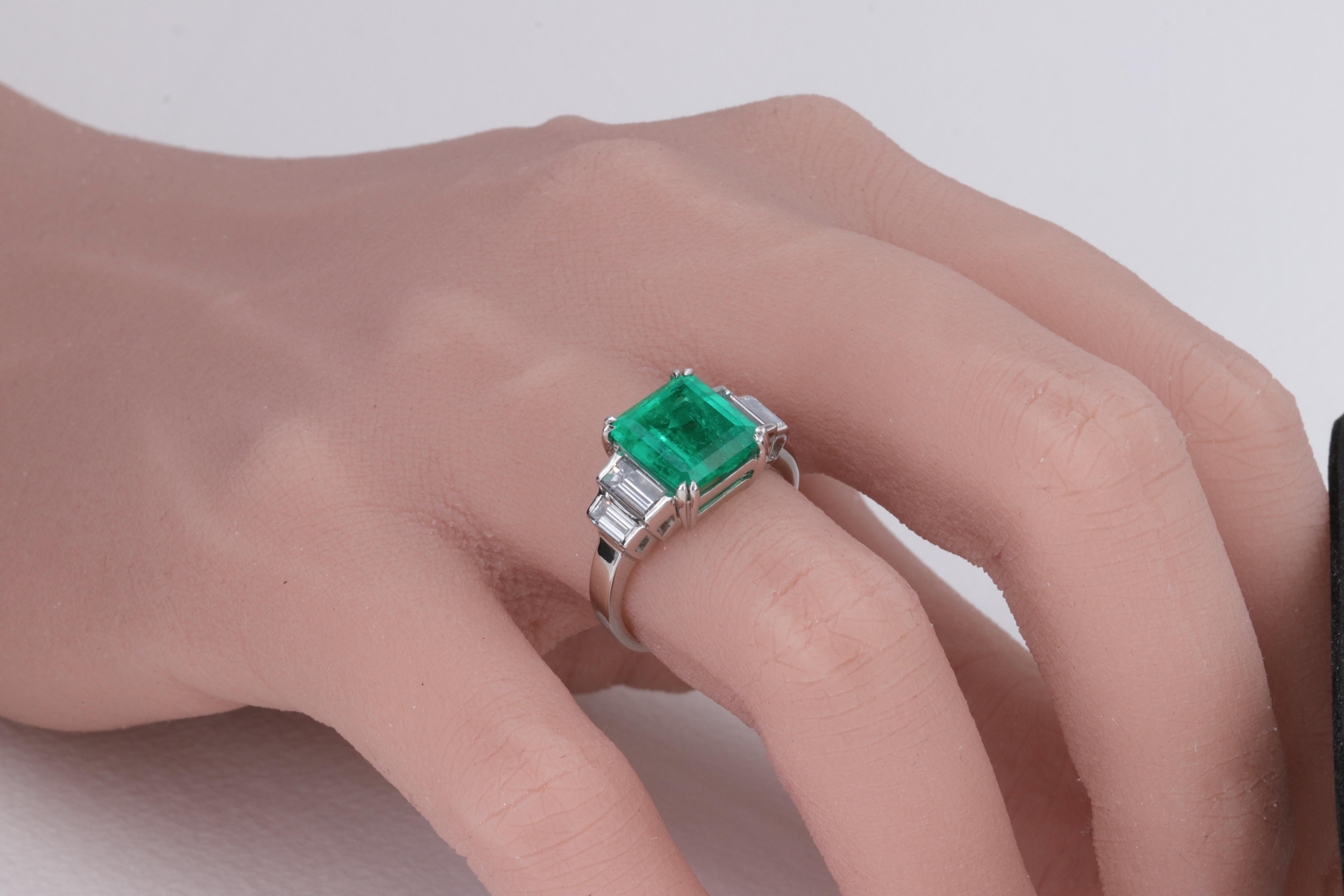 Colombian Emerald GIA and Baguette Diamond 5 Stone Platinum Ring

This well crafted platinum 5 stone emerald and diamond ring is set with a gorgeous 3.27 carat Colombian Emerald center stone with a rich vibrant green color, and well matched