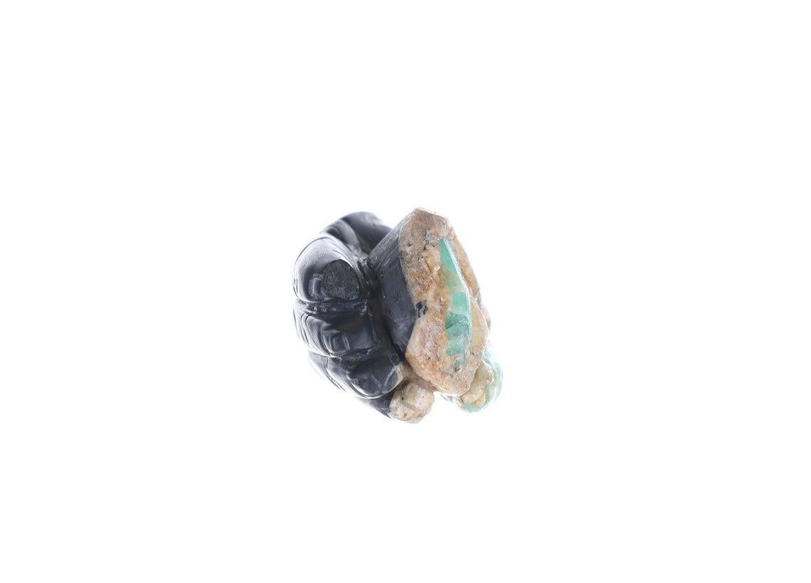 This is a beautiful and one-of-a-kind rough Colombian emerald hand sculpture. Displaying a hand-carved, hand holding the holly rough Colombian emerald crystals. The emerald version of the Midas Touch, with its emerald rough thumb.

Rough
