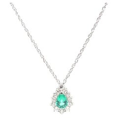Colombian emerald pendant necklace with diamond halo in platinum Colombian emerald pendant necklace with diamond halo in platinum