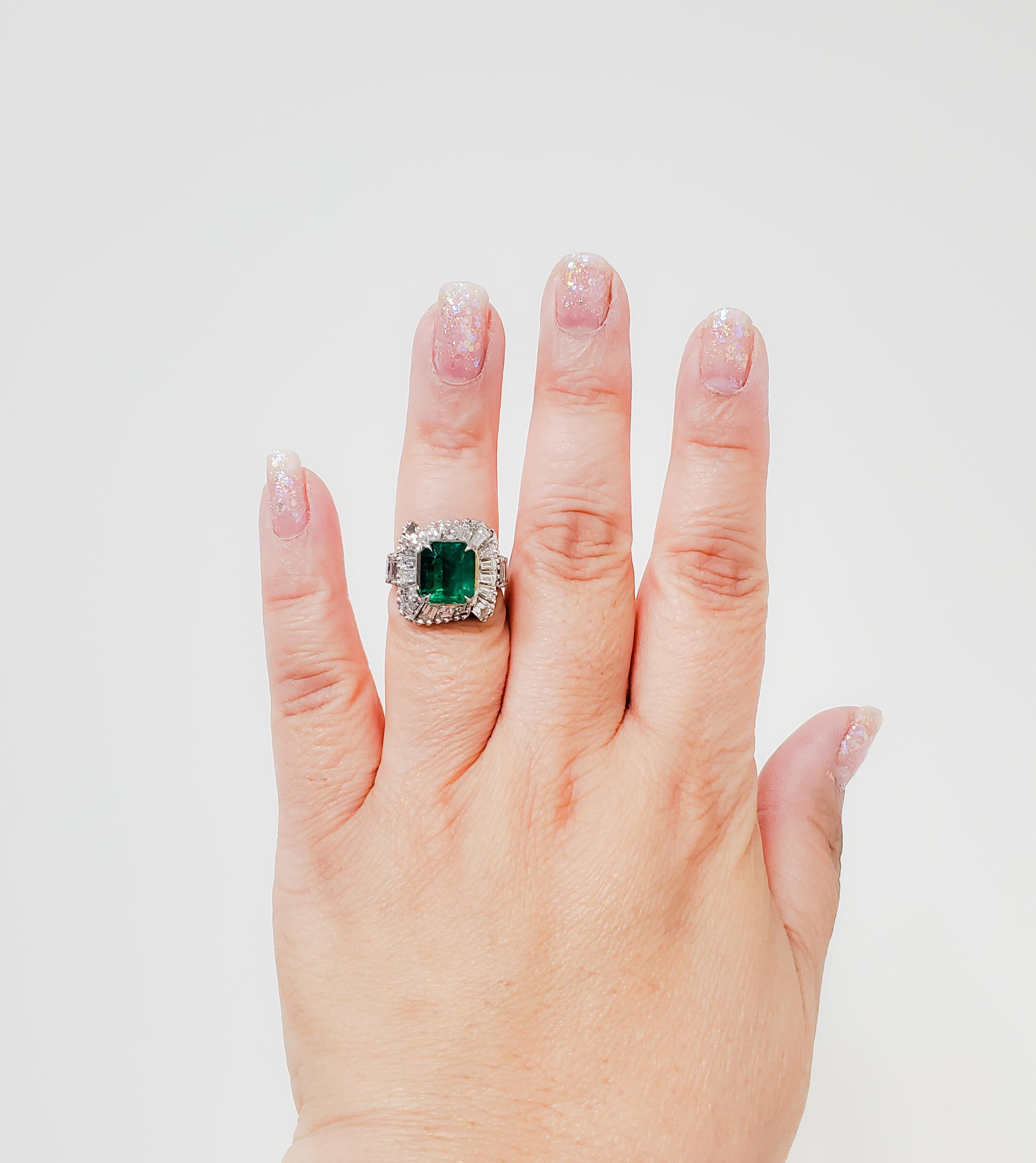 Spectacular deep green with bright crystal Colombian emerald rectangular emerald cut weighing 3.69 ct. with 2.00 ct. of good quality white and bright diamond baguettes and emerald cuts in a handcrafted platinum mounting.  Ring size is 6.5.  Such a