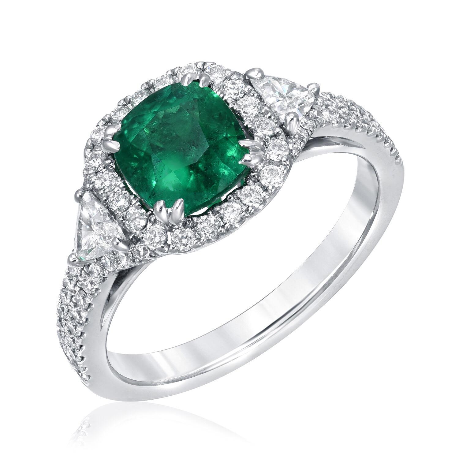 Cushion cut Colombian Emerald ring set with a 1.39 carat Emerald and a total of 0.63 carats of trillion and round brilliant diamonds. This Emerald engagement ring or cocktail ring is crafted in 18K white gold.
Emerald ring size 6.5. Resizing is