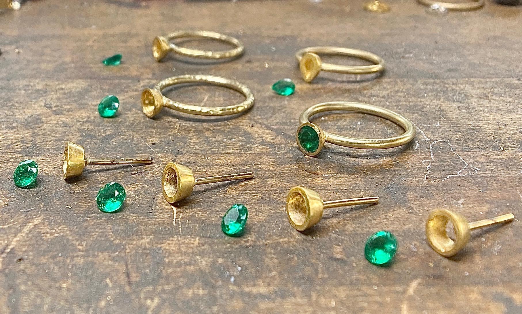 Hand forged in California by our master goldsmith, these earrings feature Colombian emerald round brilliant emeralds, set in 22 karat gold. These earrings are 5.25 mm in diameter. Enjoy the 