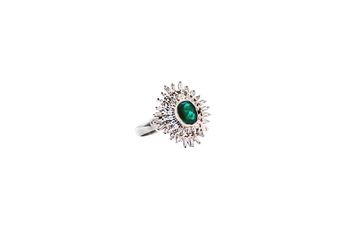 Colombian Emerald, Spray Diamond Cocktail Ring, 18 Karat White Gold
Spectacular colored, oval shaped emerald is a deep green color measuring 4.95 x 6.65 mm in diameter weighing approximately 1.25 carat.
The diamonds spray of diamonds consists of