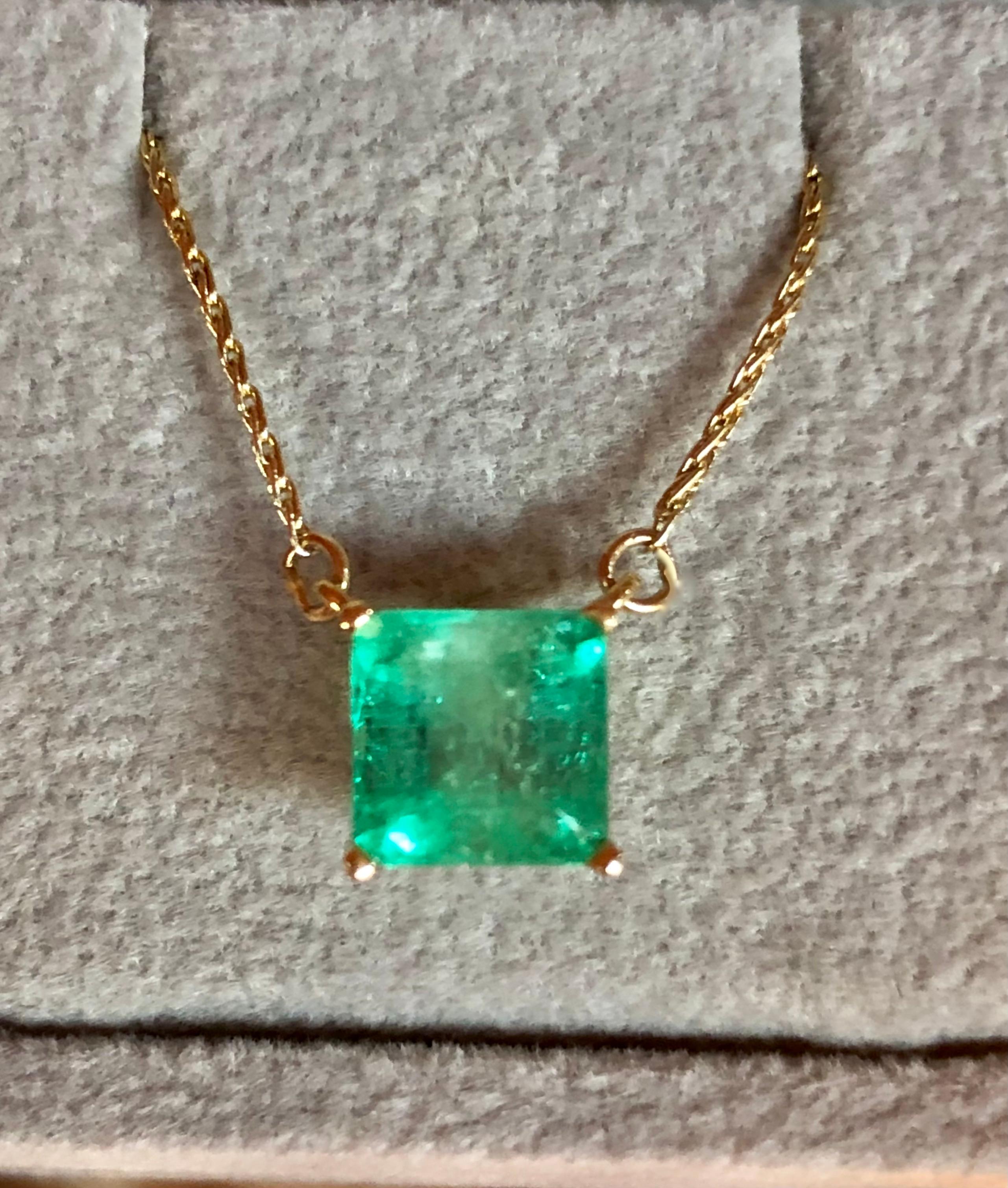 Square Cut Colombian Emerald Solitaire Pendant Drop Necklace in 14K Yellow Gold.
This necklace features a medium green natural Colombian emerald, clarity: SI, Weight 1.68 Carat, Square Shaped 7.0mm x 7.0mm prong-style setting. 
Wheat Chain 14K