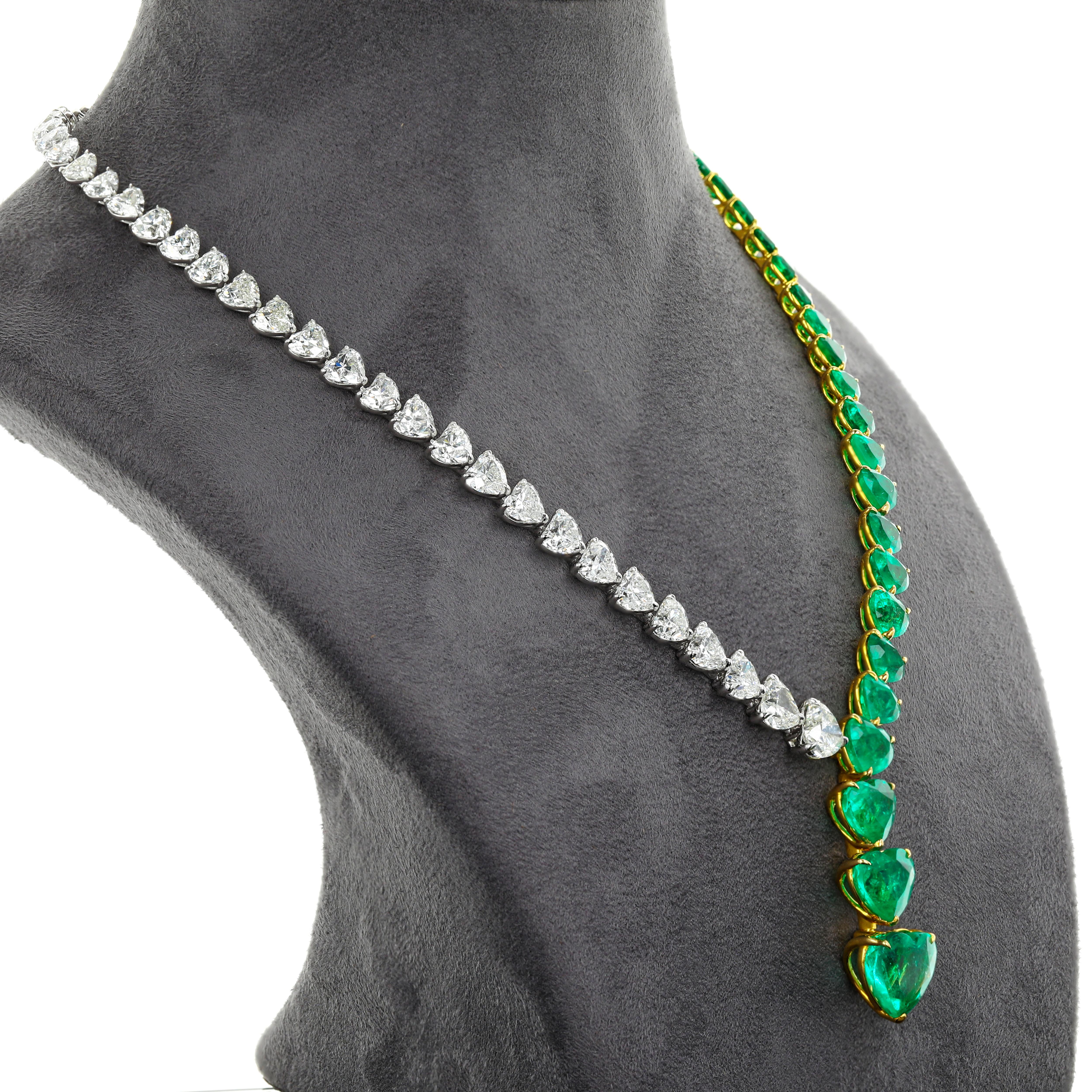 A modern necklace showcasing vibrant and color-rich heart shaped Colombian emeralds, set 
alongside graduating heart shaped Diamonds in a beautiful design. The necklace has been set in 18K white gold with 28 pieces of emeralds that weigh 37.42