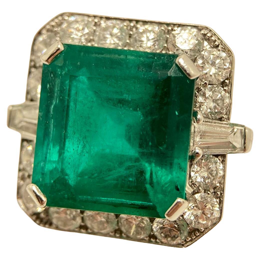 This exceptional ring showcases the timeless allure of a natural Colombian emerald sourced from the legendary Muzo mine, renowned worldwide for producing some of the most sought-after emeralds in history. At the heart of the design lies a