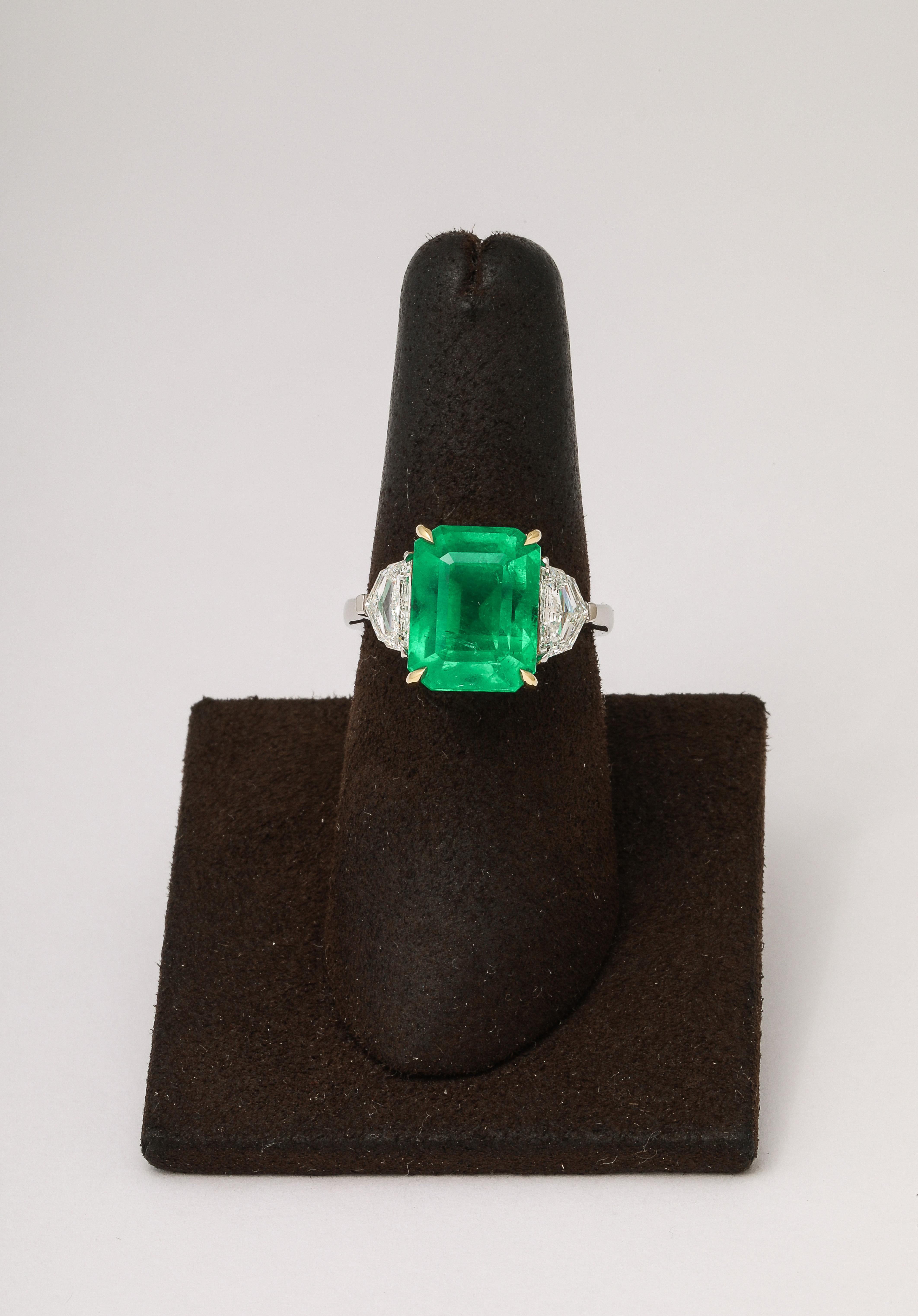 
A spectacular Emerald with Vivid Green color.

6.97 carat emerald cut emerald. 

.78 carats of epaulette side diamonds.

Custom made platinum and 18k yellow gold mounting. 

Such a VIBRANT emerald - pictures do not do this stone justice.