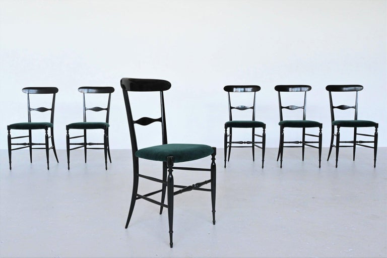 Very nice set of 6 Campanino dining chairs designed by Colombo Sanguineti, manufactured by Sedie e Mobili Sanguineti Chiavari, Italy, 1950. Fantastic Italian slim shaped design and amazingly light. These chairs have a black lacquered wooden frame