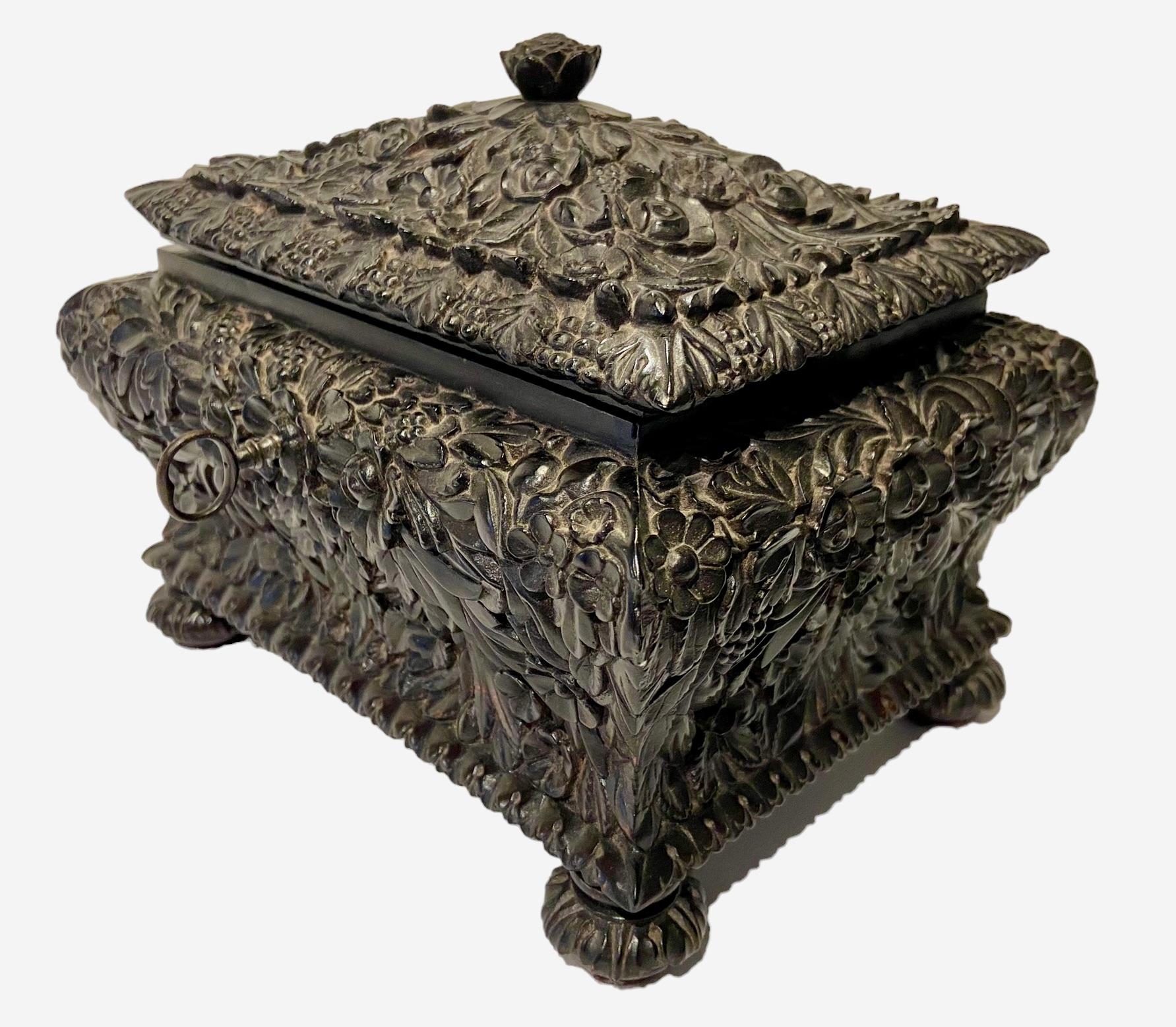 A Dutch colonial box from Batavia in the former Dutch East Indies.
Hand-carved with floral motives in ebony, used for jewelry or letters, 
ca. 1800. Original hinges and lock, including key.
The inside is finished with snakeskin and velvet.
 
