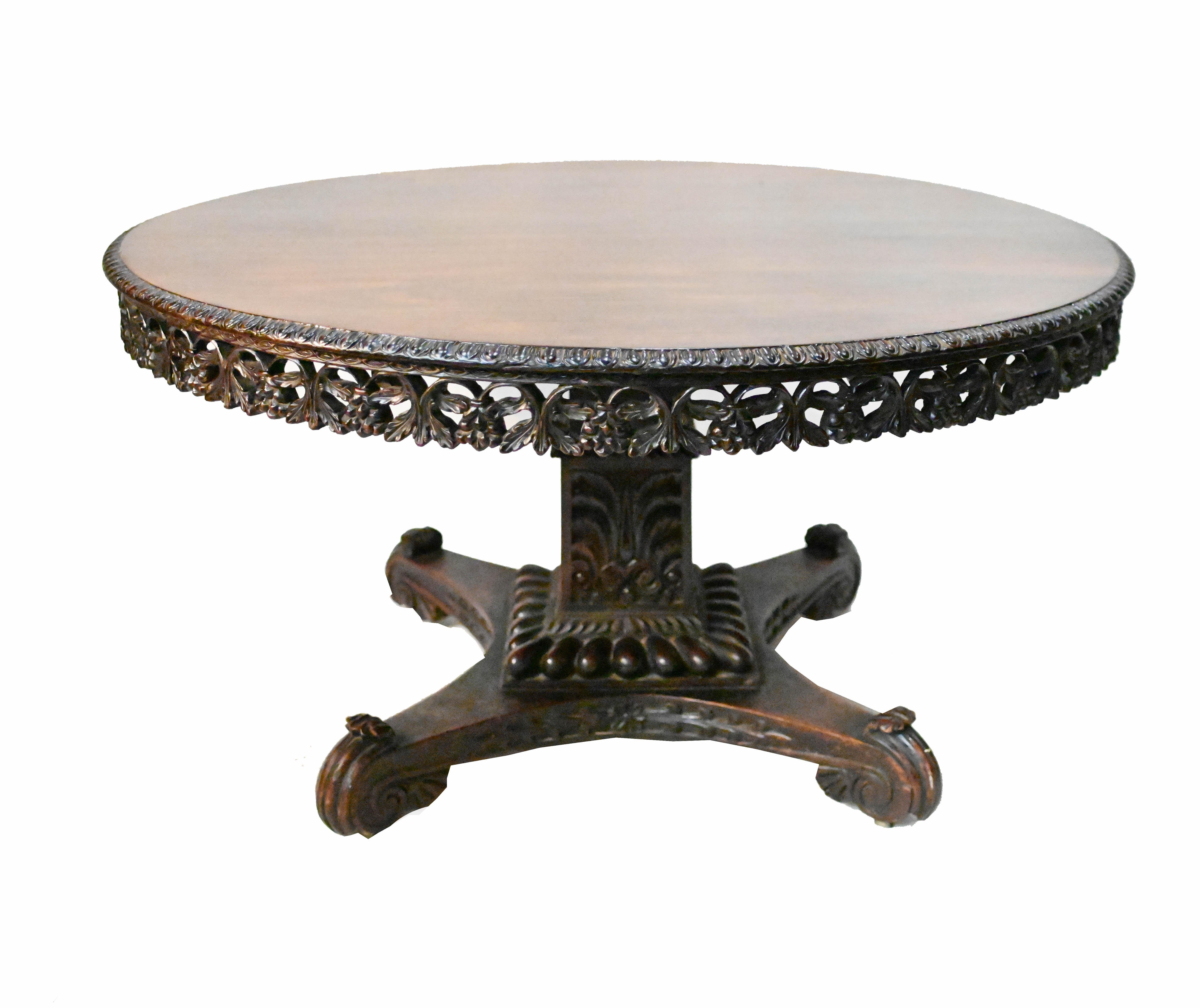 You are viewing a gorgeous Colonial - possibly Myanmar (Burmese) round dining table
Hand carved from padauk wood with intricate carving particularly on the frieze around the edge of the top
The legs and base also intricately hand carved with various
