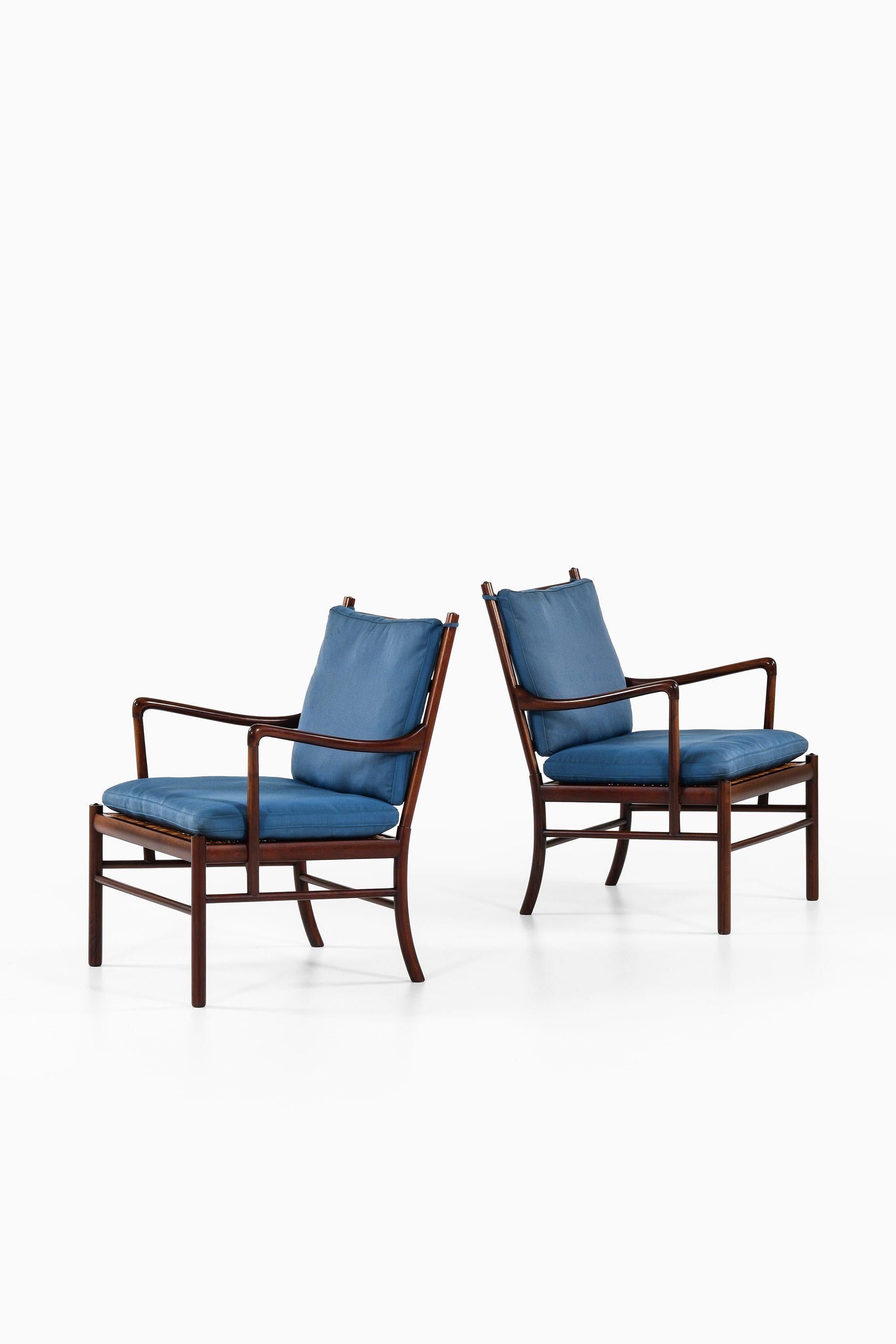 Pair of Easy Chairs in Mahogany, Woven Cane and Original Fabric by Ole Wanscher, 1960's

Additional Information:
Material: Mahogany, woven cane and original fabric
Style: Mid century, Scandinavia
Rare pair of easy chairs model Colonial
Produced by
