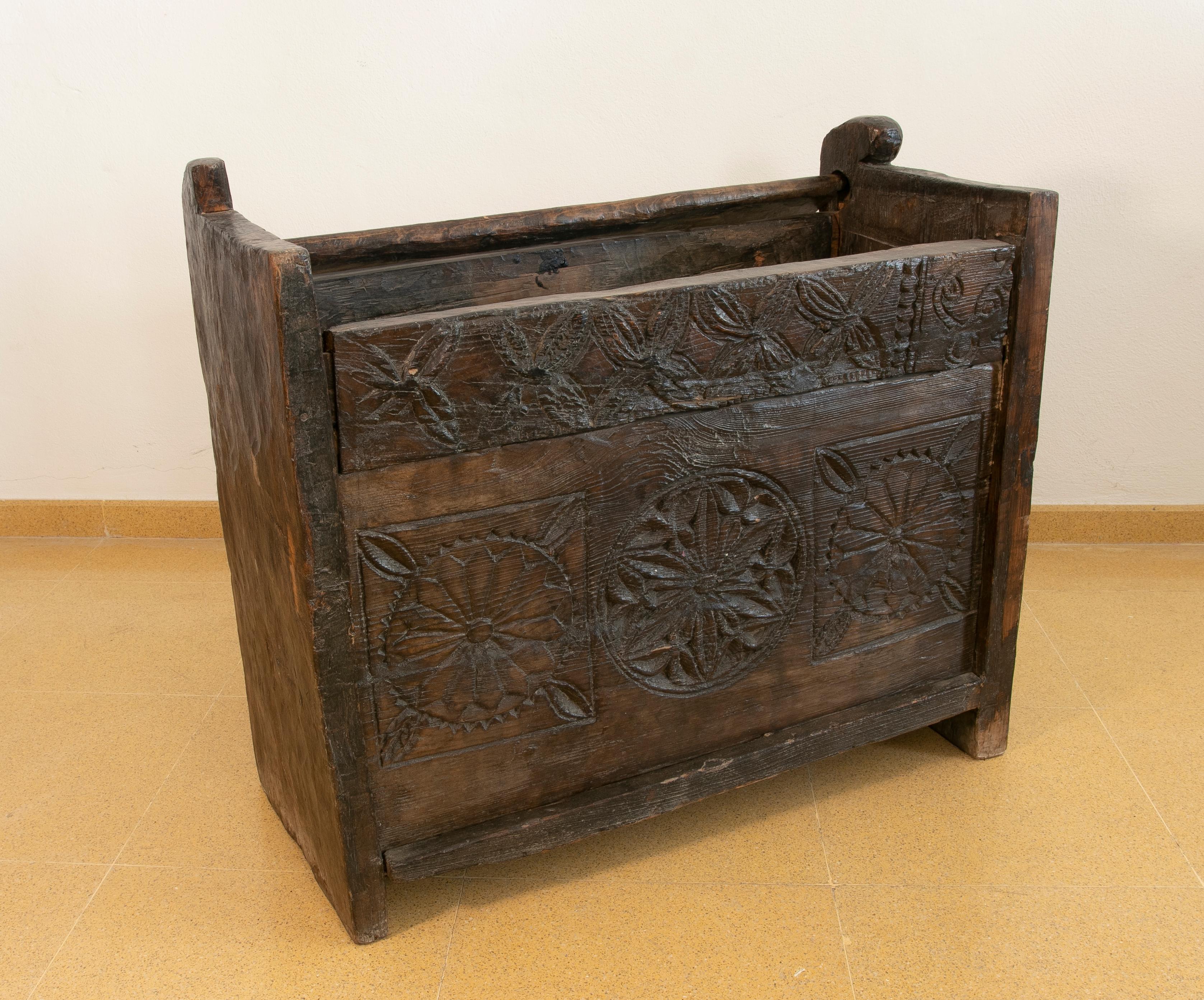 Colonial hand-carved wooden box with lid on top.
