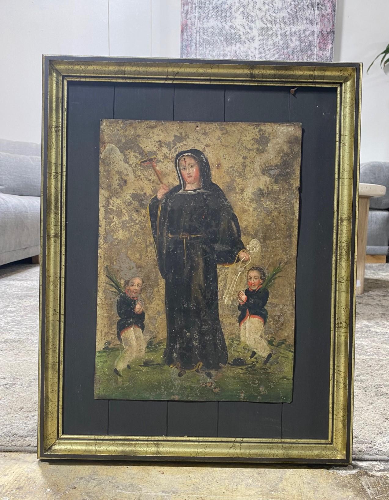 A beautiful 19th century Spanish Colonial Mexican Folk Art ex-voto retablo lámina painting featuring Saint Rita De Cascia. Santa Rita is almost always depicted as she is here, with a trickle of blood and a thorn deeply embedded in her forehead.