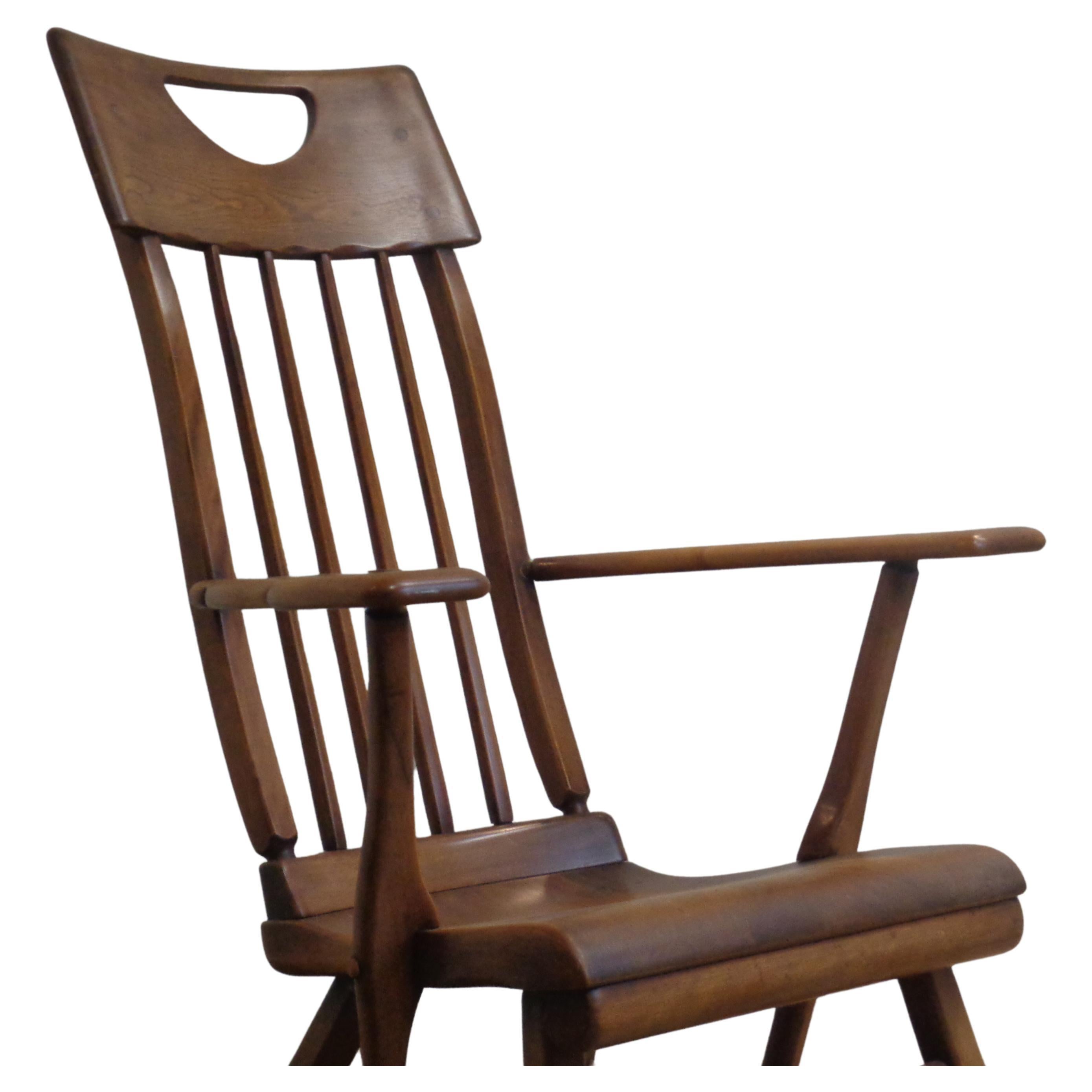 American Colonial modernist style solid maple tall back rocking chair designed by Herman de Vries for Sikes Furniture Company in good original vintage condition w/ nicely aged warm color patina. Circa 1930's. Measures 41