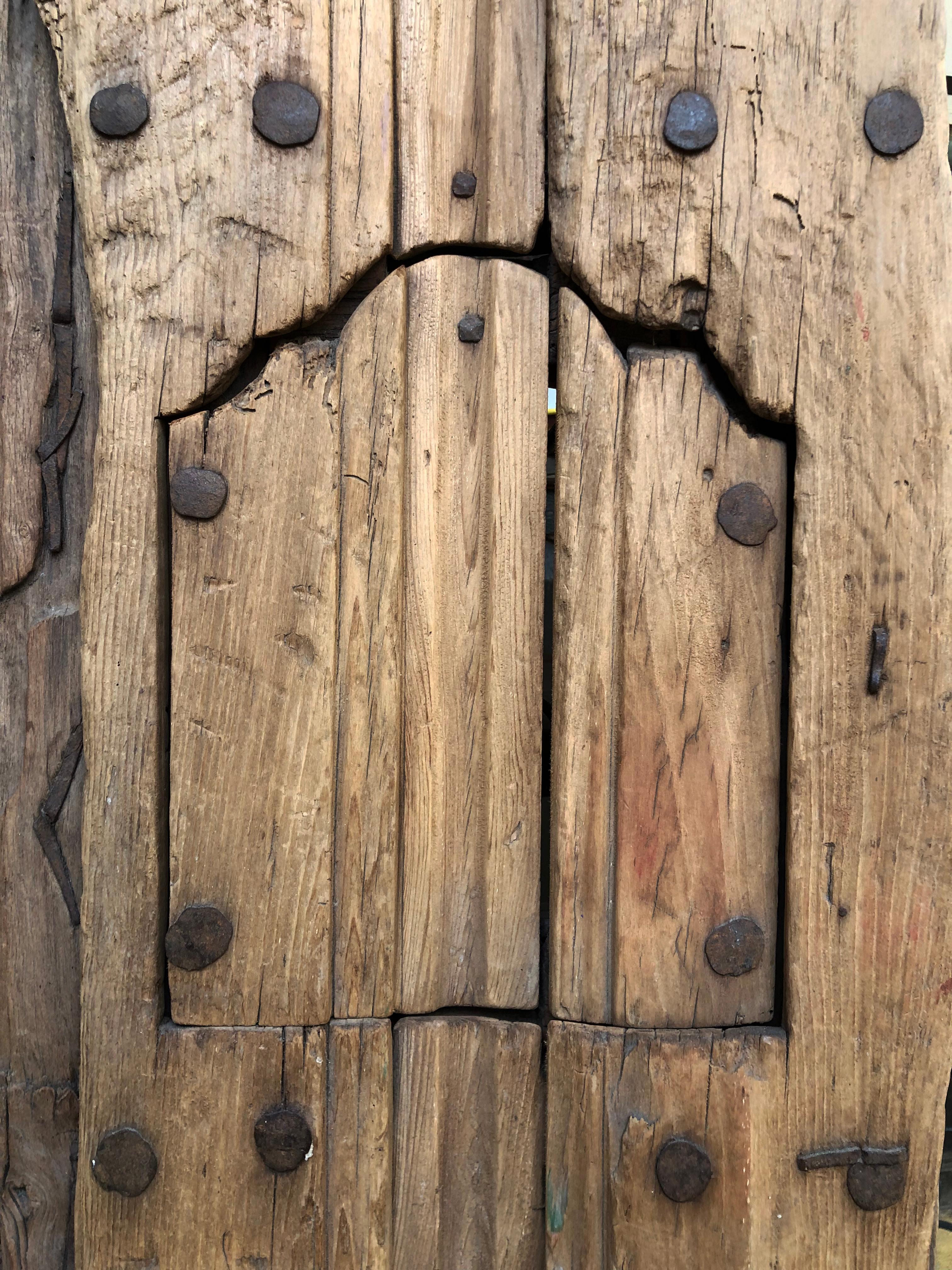This beautiful piece is part of a bigger door, it was made with Sabino wood and has forging ironwork nails, this type of wood gets an amazing patina as the centuries pass. It has all the iron works intact, the type of hinge on this door are called