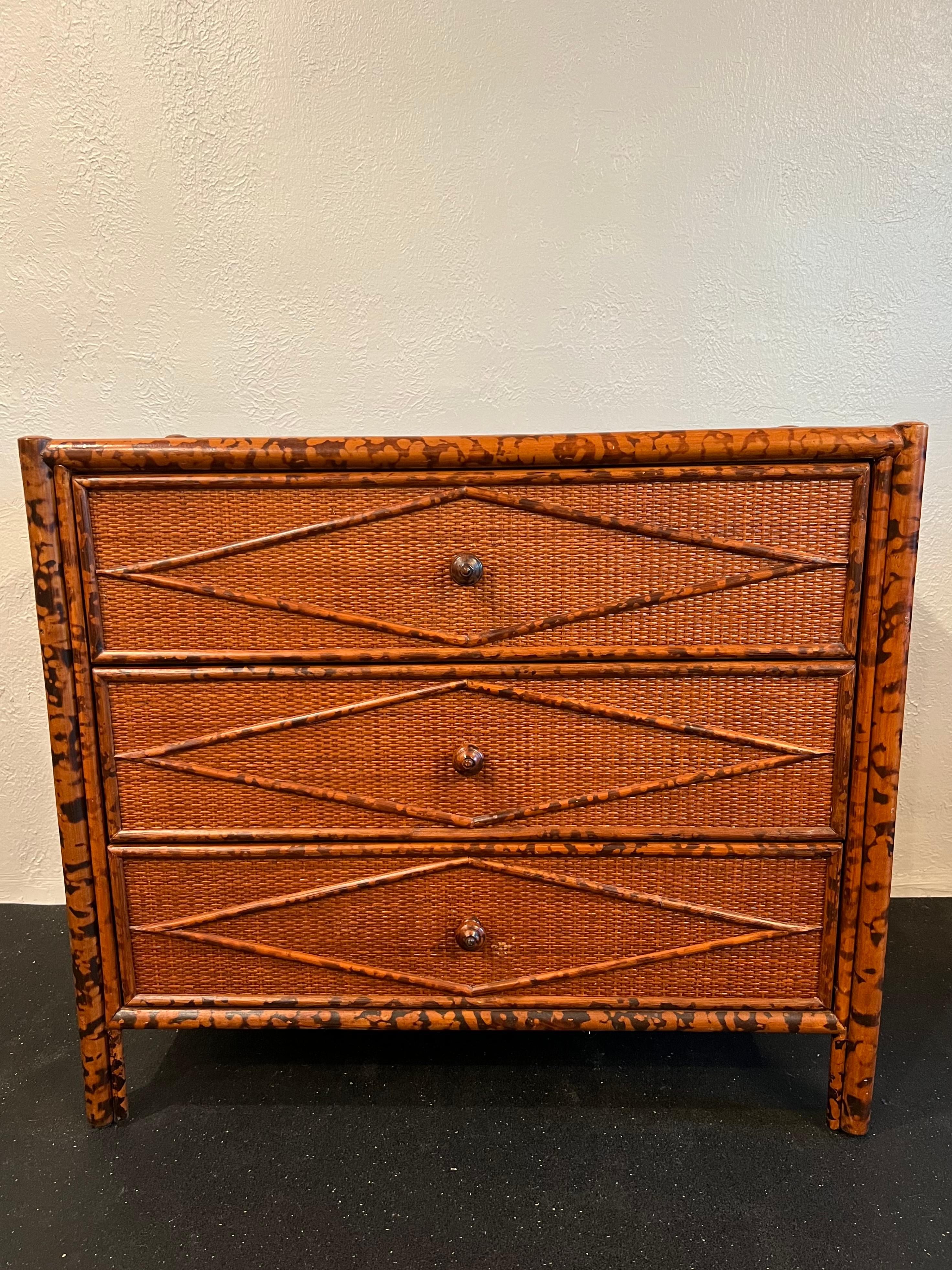 British colonial style burnt bamboo and cane chest of drawers. Slight wear to finish of cane (please refer to photos). Matching pair of nightstands and dresser available in separate listings. 

Would work well in a variety of interiors such as