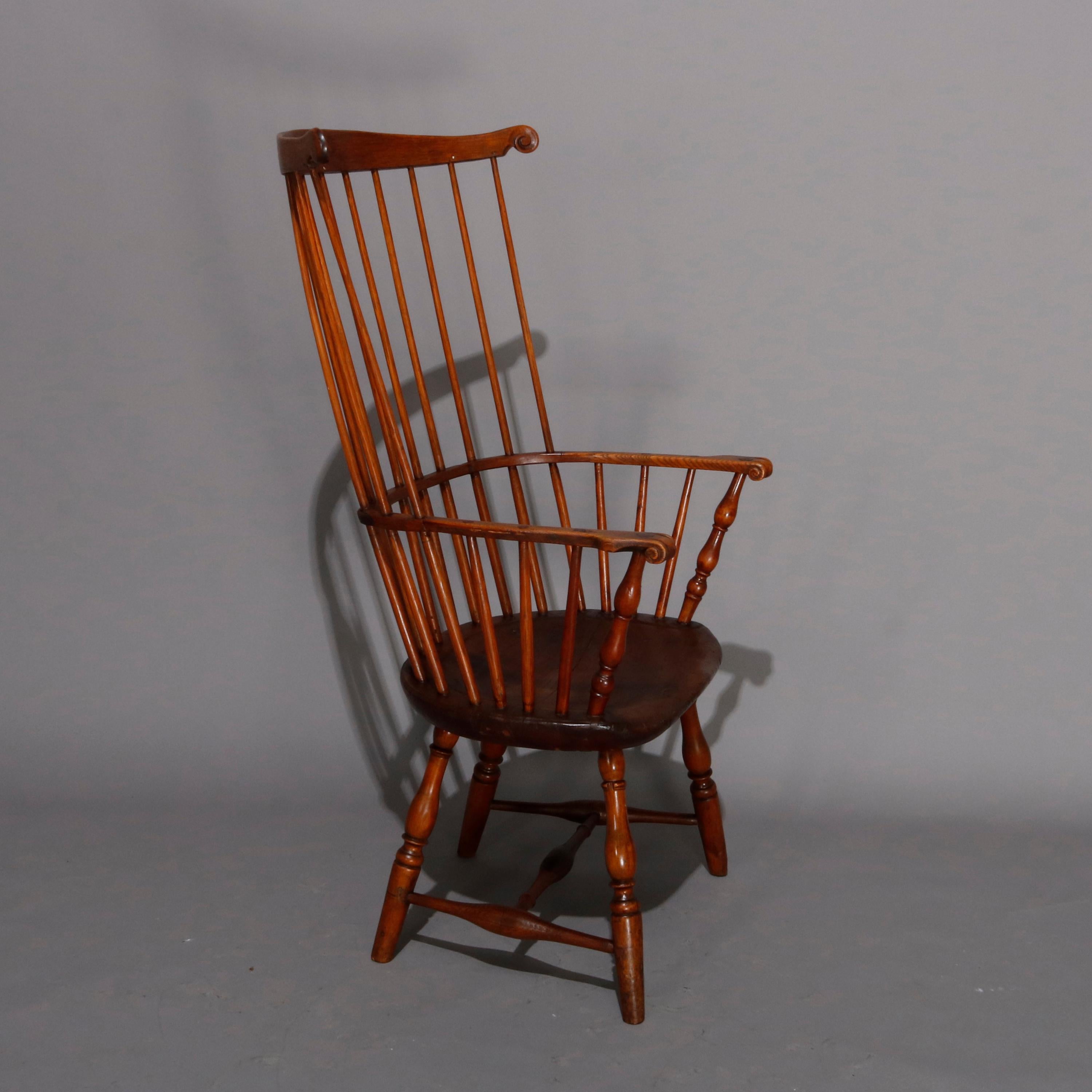 A Colonial style Philadelphia Windsor style chair features oak pegged construction with fan back and arms having spindles surmounting formed seat and raised on turned legs, 20th century

Measures: 44.5