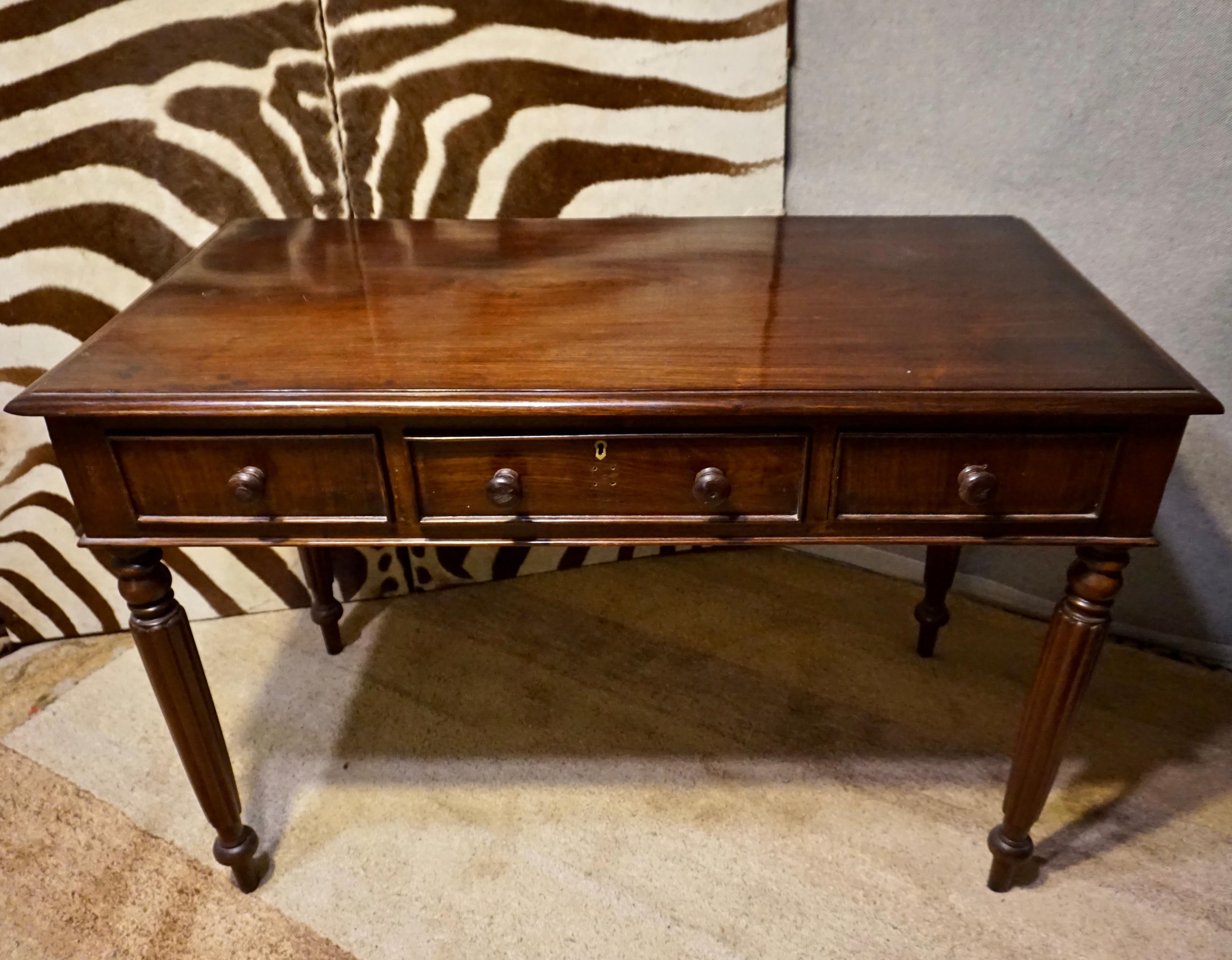 Circa 1890

Solid Rosewood Colonial writing desk in good condition. Old growth timber is visible as the top is constructed from a single piece of Rosewood that shows beautiful grain. Legs are hand carved. Knobs have been replaced with central knob