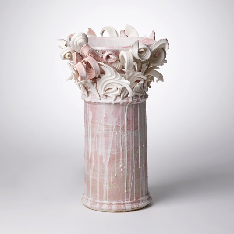 Colonnade II is a unique handmade coloured stoneware ceramic sculptural vase in dusky pink and white by the British artist Jo Taylor. The central form has been thrown on the potter's wheel and also hand-built, then adorned with architectural