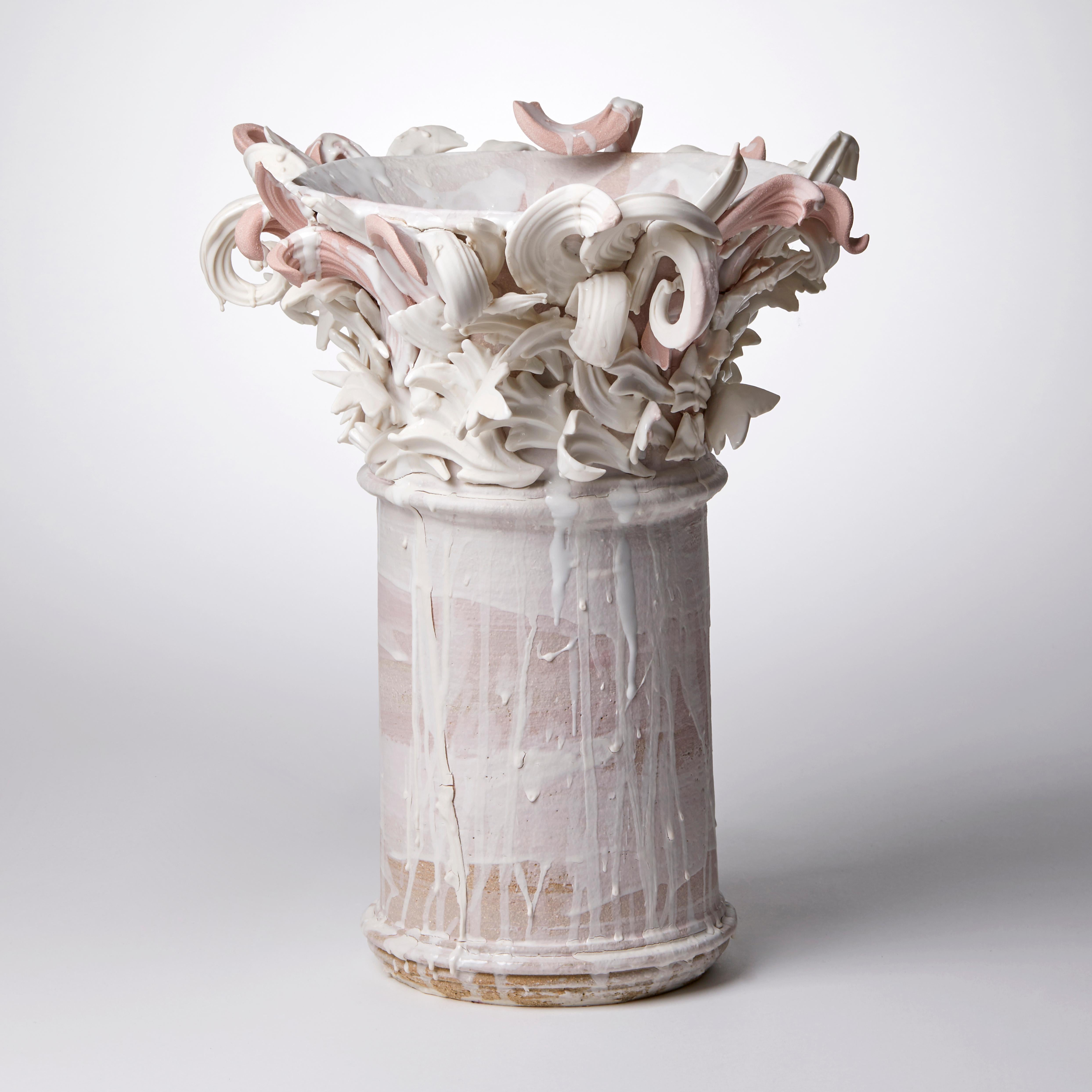 Colonnade III is a unique handmade coloured stoneware ceramic sculptural vase in dusky pink and white by the British artist Jo Taylor. The central form has been thrown on the potter's wheel and also hand-built, then adorned with architectural
