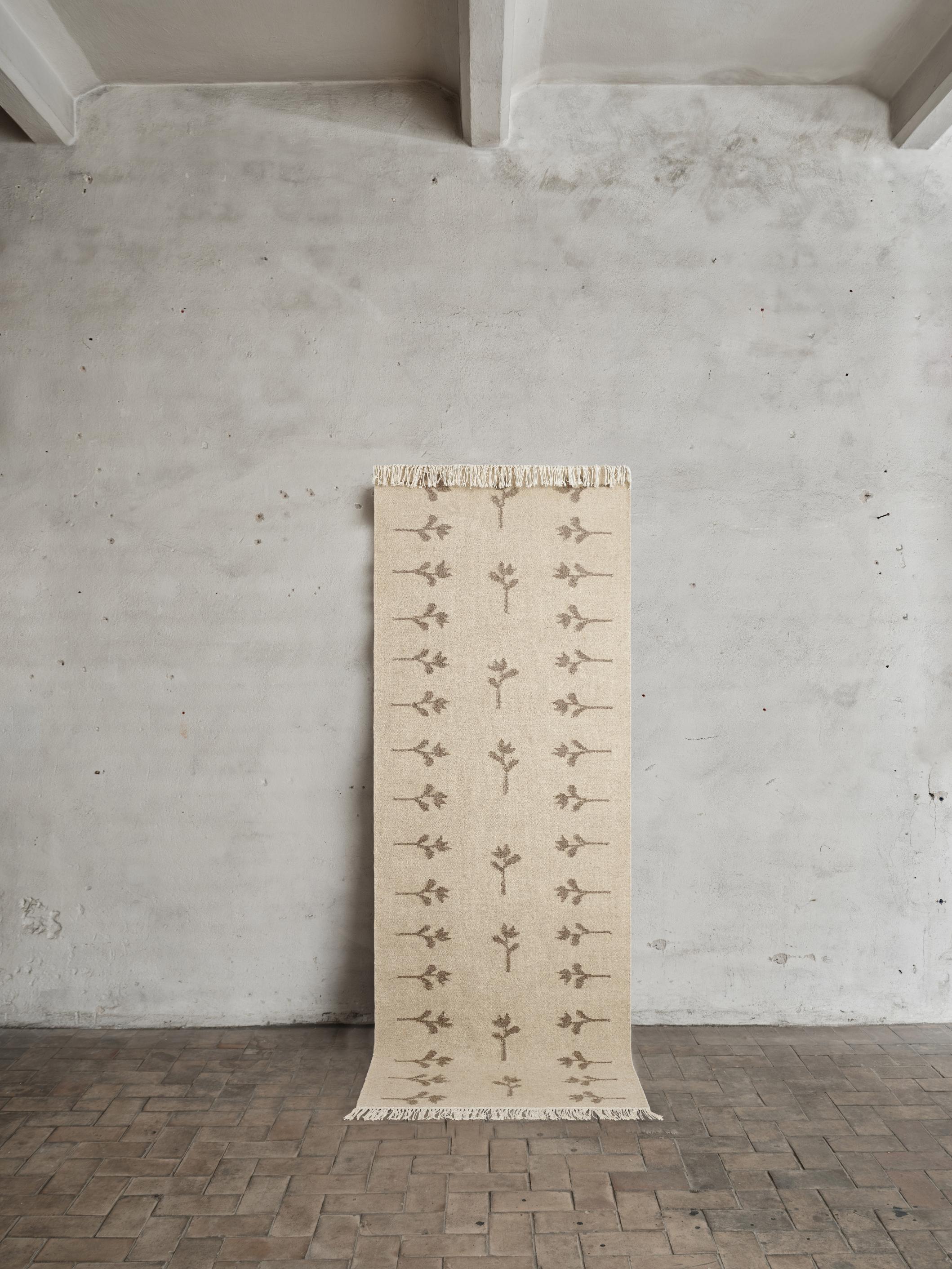 Colonnade no.08 Rug by Cappelen Dimyr
Dimensions: D 85 x H 240 cm (excl fringes)
Materials: 85% Wool, 15% cotton

Colonnade no.08 & Rug no.17 is a light flat-woven, handmade rug in natural wool. The rug is designed in a mid-beige foundation with