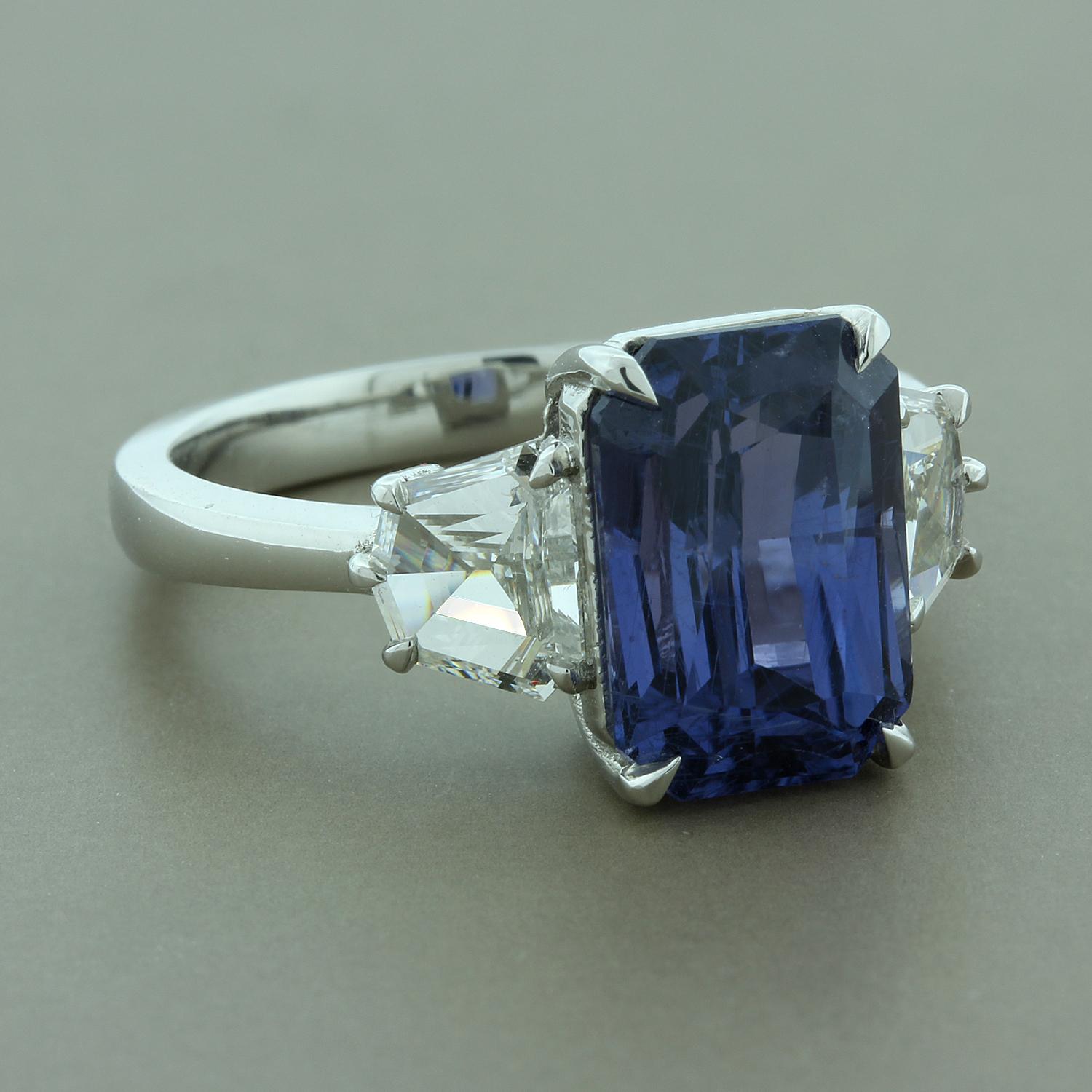This classic 3-stone ring features a GIA certified 5.55 carat radiant cut color change sapphire. In daylight you will see a soft bluish violet color and under candlelight watch the sapphire deepen into a rich purple. There are two cadillac cut
