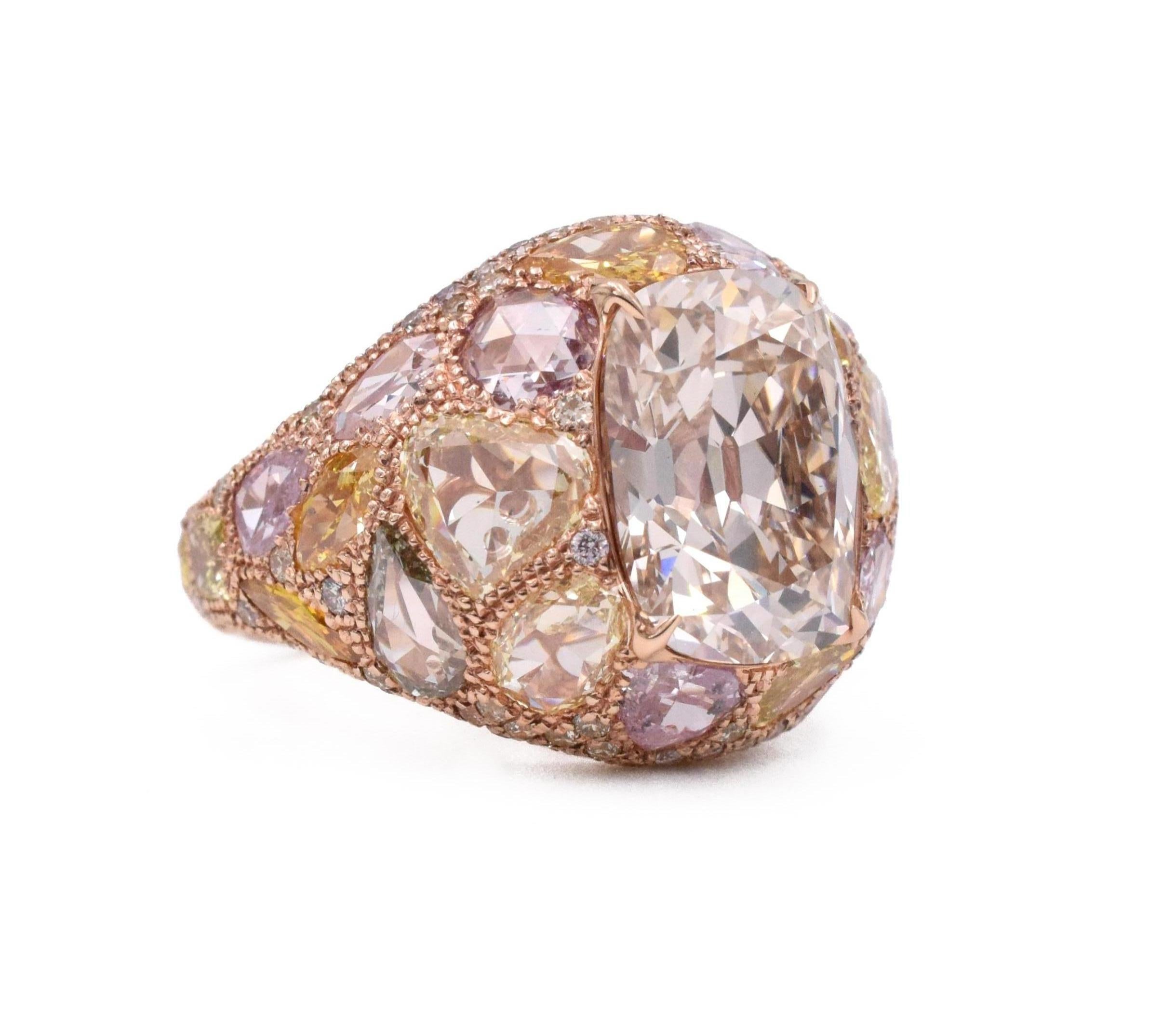 NALLY Diamond and Colored Diamond Ring
Set with a cushion-cut diamond weighing 5.17 carat & accented by variously-cut diamonds   ranging in hues including very light to light bluish green to blue, very light to medium purplish pink to pink, very