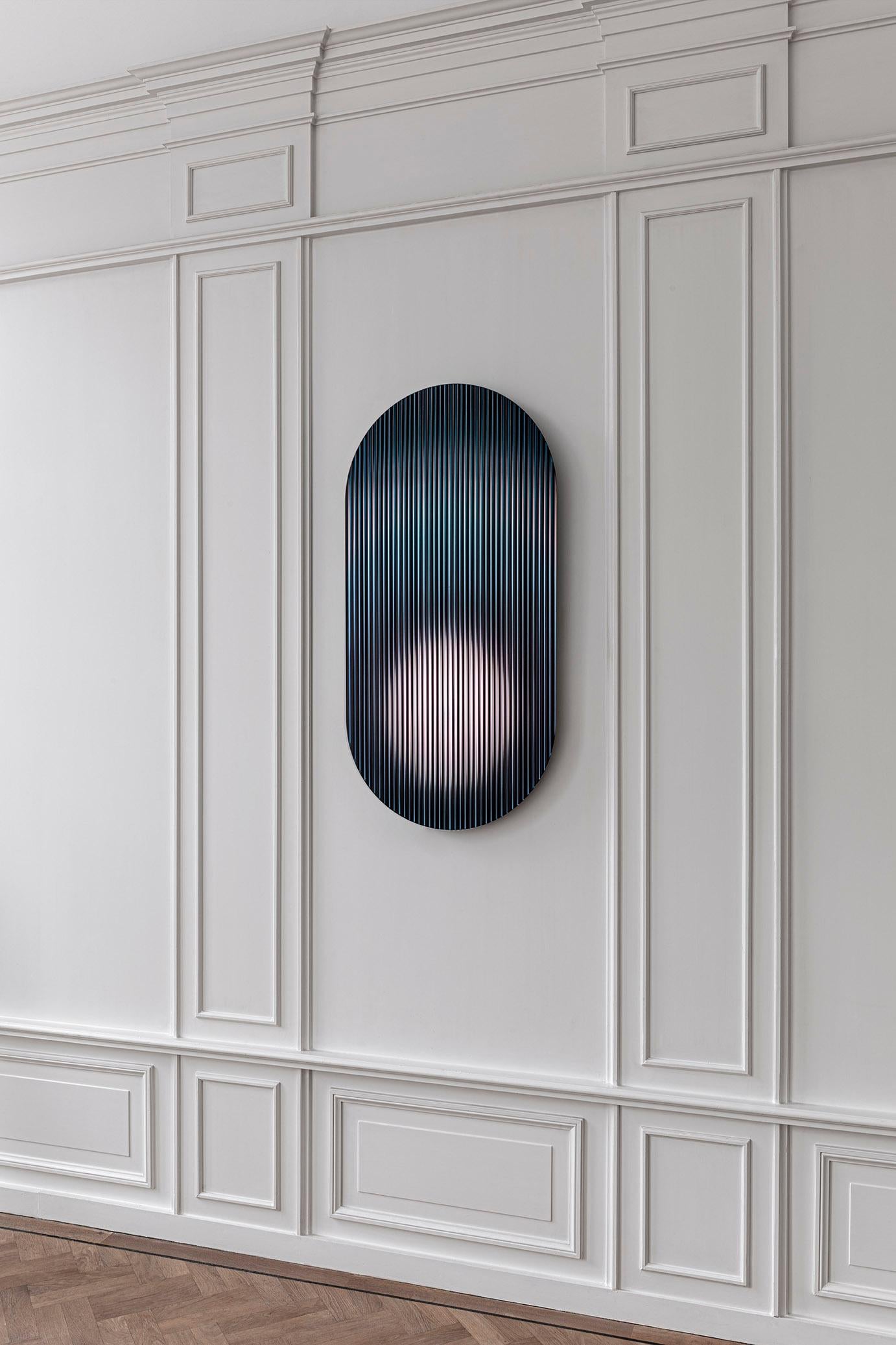The reflective, coloured, rippled glass panel – designed to add a palette of colour to spaces – reflects light in spaces and adds movement and color whilst creating abstracted reflections. The piece disperses light through its rippled surface